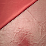 Softly folded Dusty Peach Pink foiled spandex showing metallic shine and flexible hand for costumes, eveningwear and creative sewing