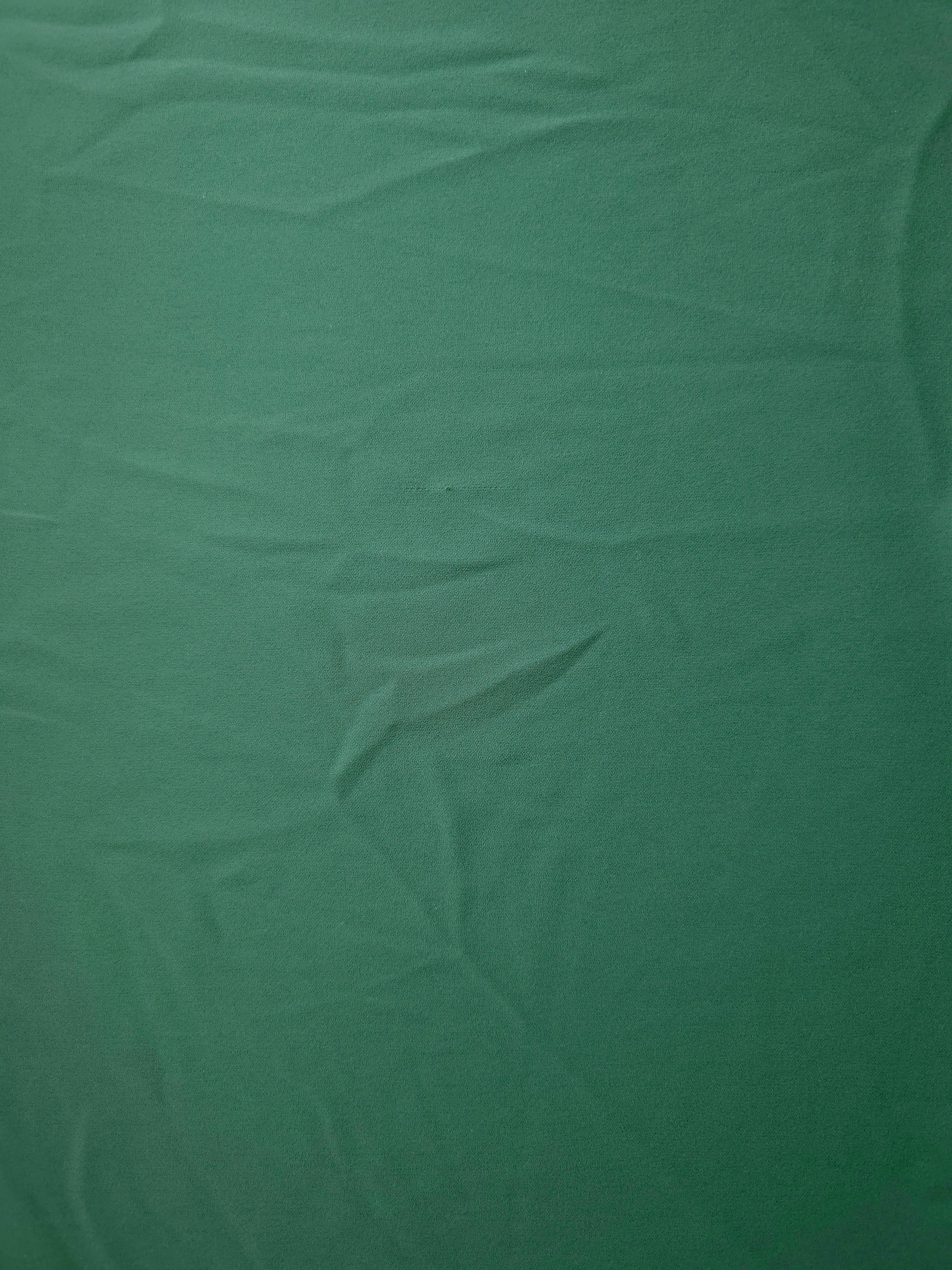 Flat view of Dusty Pine Green Italian crepe, smooth polyester dressmaking fabric with a refined silky-feel surface