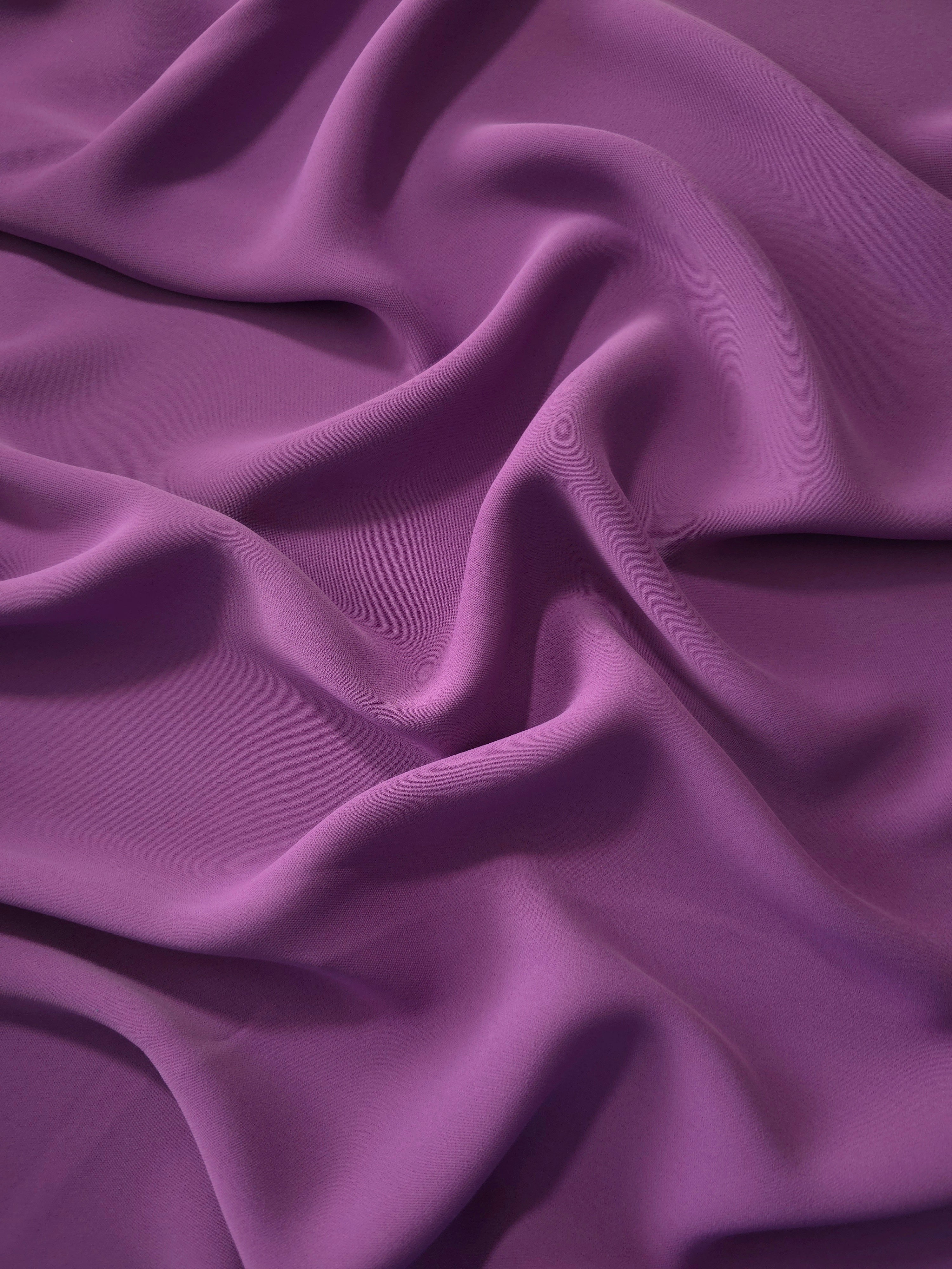 Dusty Plum Korean polyester dress fabric shown in draped folds for occasionwear, blouses and dresses