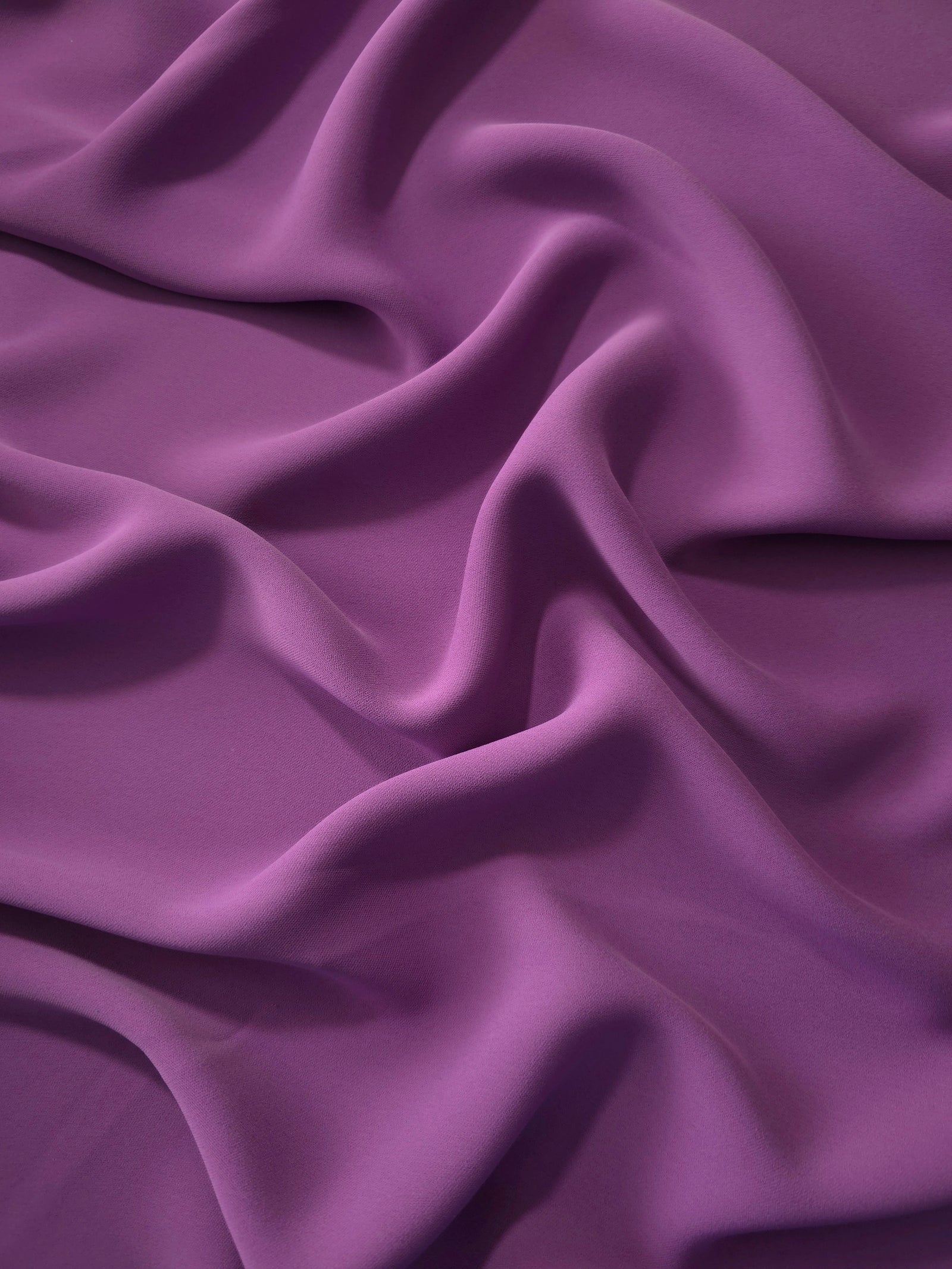 Dusty Plum Korean polyester dress fabric shown in draped folds for occasionwear, blouses and dresses