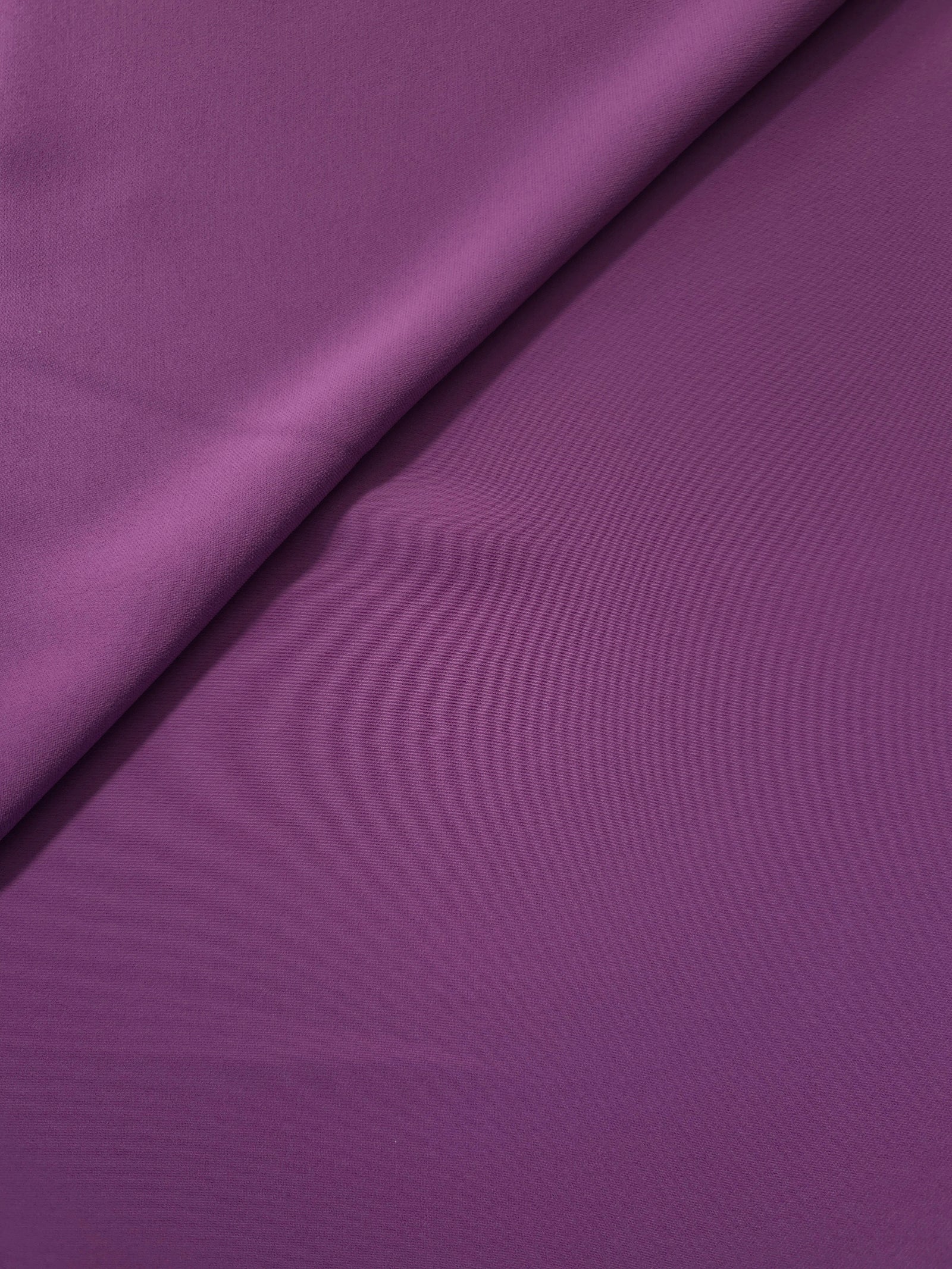 Close woven detail of Dusty Plum 100% polyester Korean crepe showing its smooth texture and soft finish