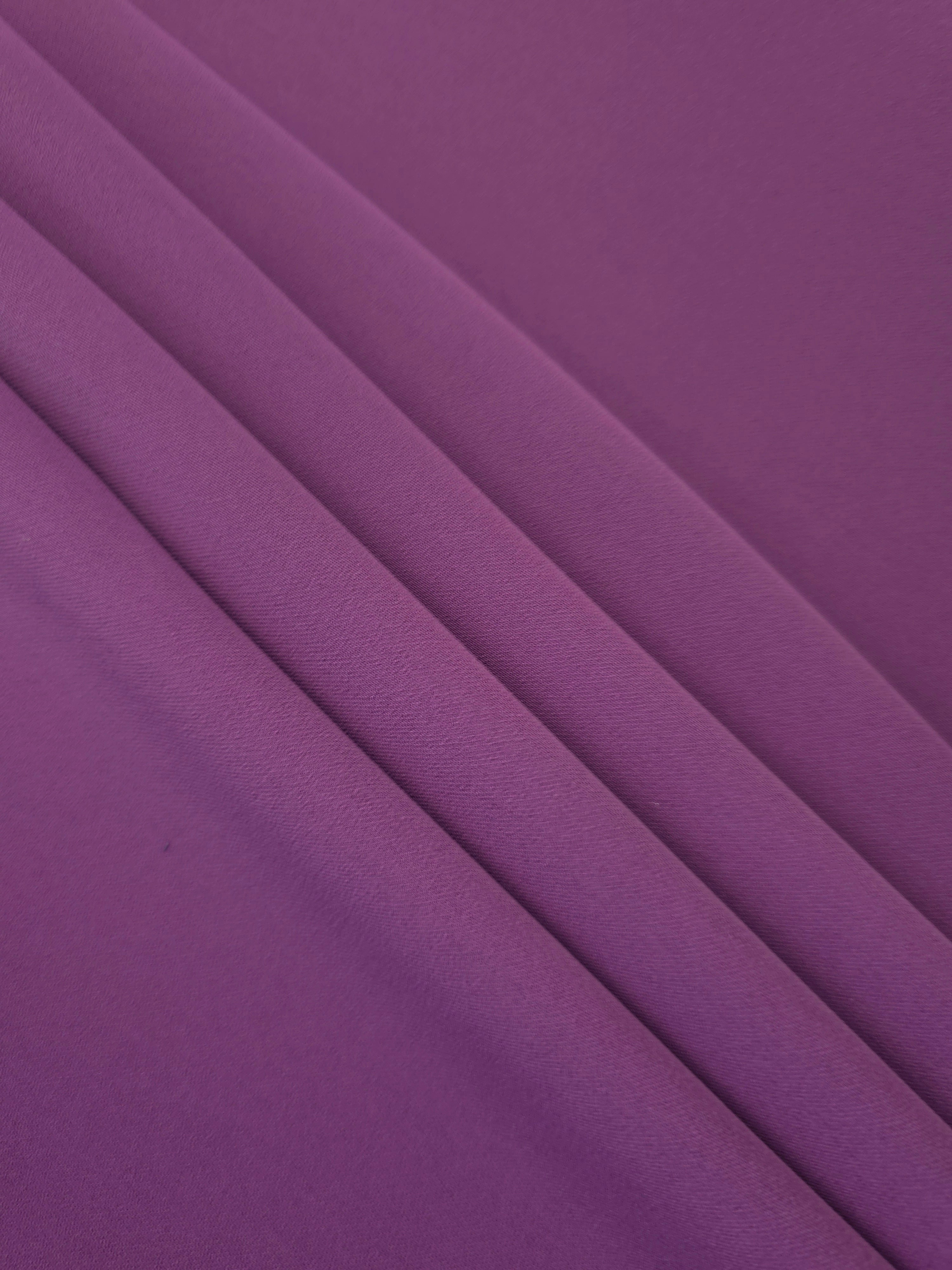 Flowing swirl of Dusty Plum Korean polyester crepe showing soft drape for blouses, dresses and abayas