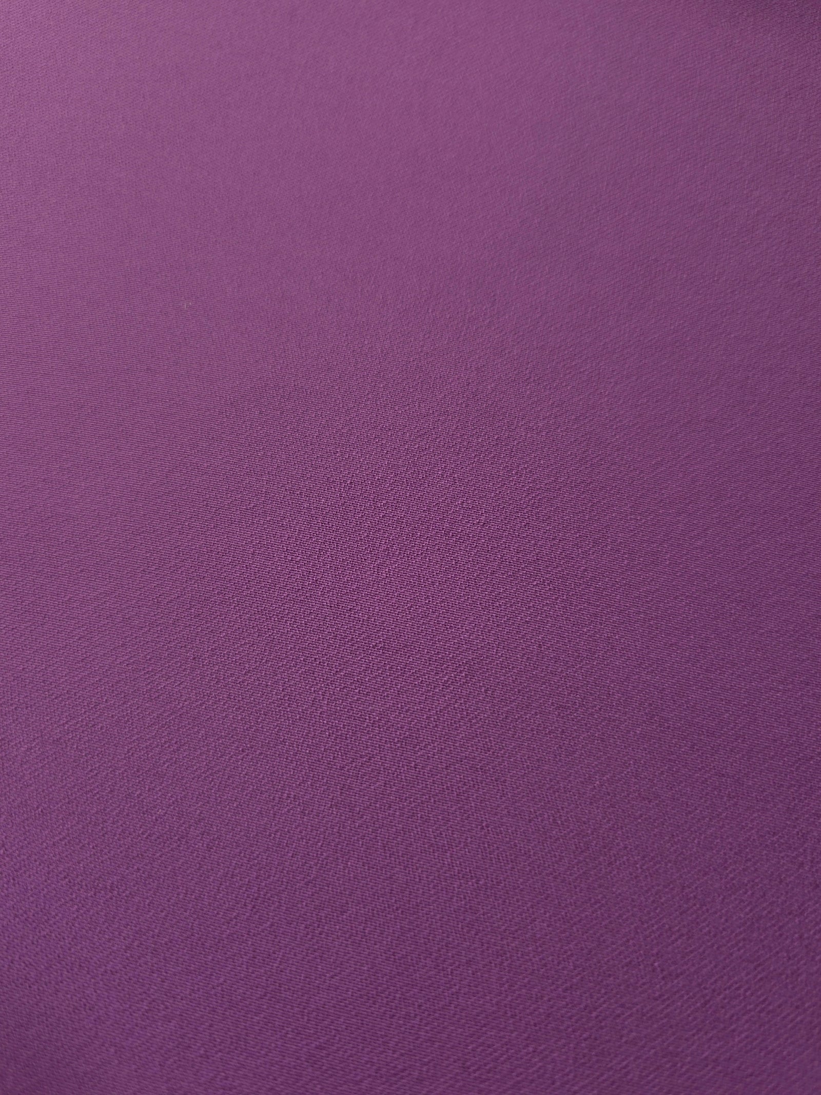 Loose fold of Dusty Plum polyester crepe showing smooth fluid drape for dresses, skirts and soft tailoring