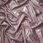Flowing folds of Dusty Rose Mauve metallic foiled spandex, showing shimmer and drape for dancewear, party dresses and performance fashion