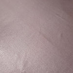 Detailed close-up of Dusty Rose Mauve foiled spandex fabric showing its luminous metallic surface and fine reflective texture