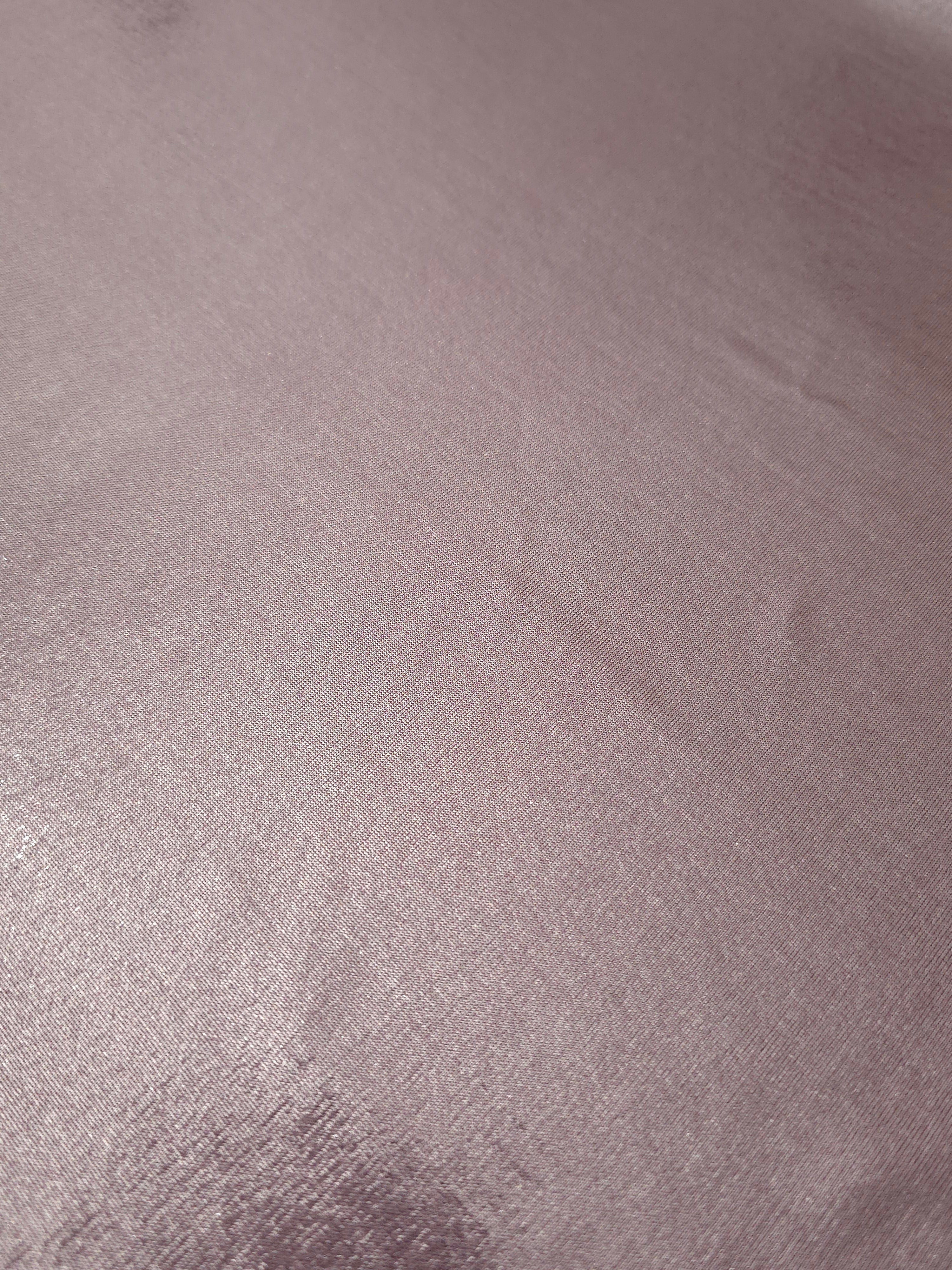 Detailed close-up of Dusty Rose Mauve foiled spandex fabric showing its luminous metallic surface and fine reflective texture