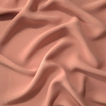 Draped folds of Dusty Rose Taupe polyester crepe showing opaque coverage and fluid movement for garment making