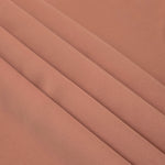 Layered Dusty Rose Taupe Korean polyester crepe showing gentle mechanical stretch and soft structure for dressmaking