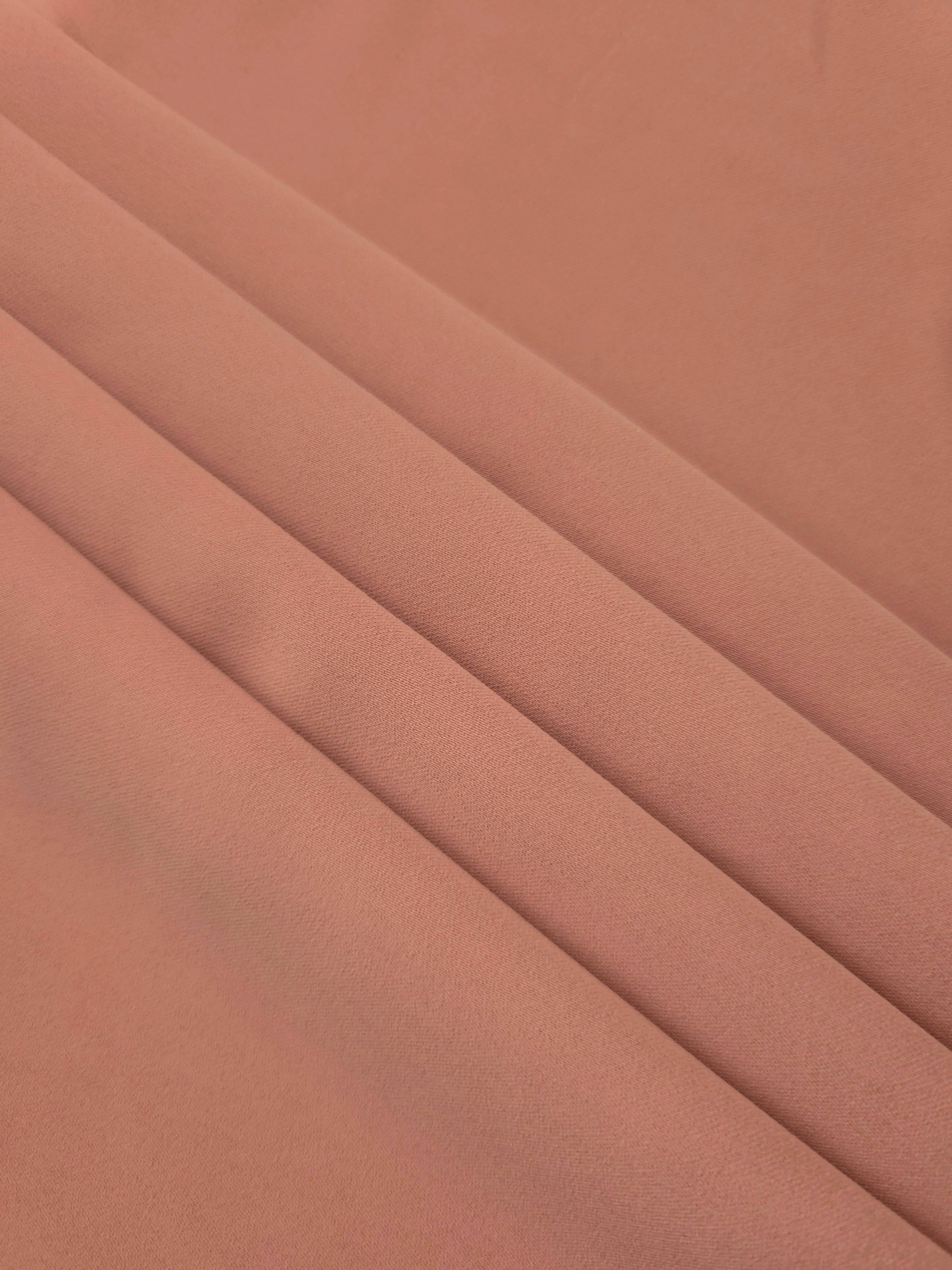 Layered Dusty Rose Taupe Korean polyester crepe showing gentle mechanical stretch and soft structure for dressmaking