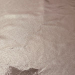 Texture view of Dusty Rose Taupe metallic stretch fabric, highlighting foil shimmer and surface detail for performance apparel