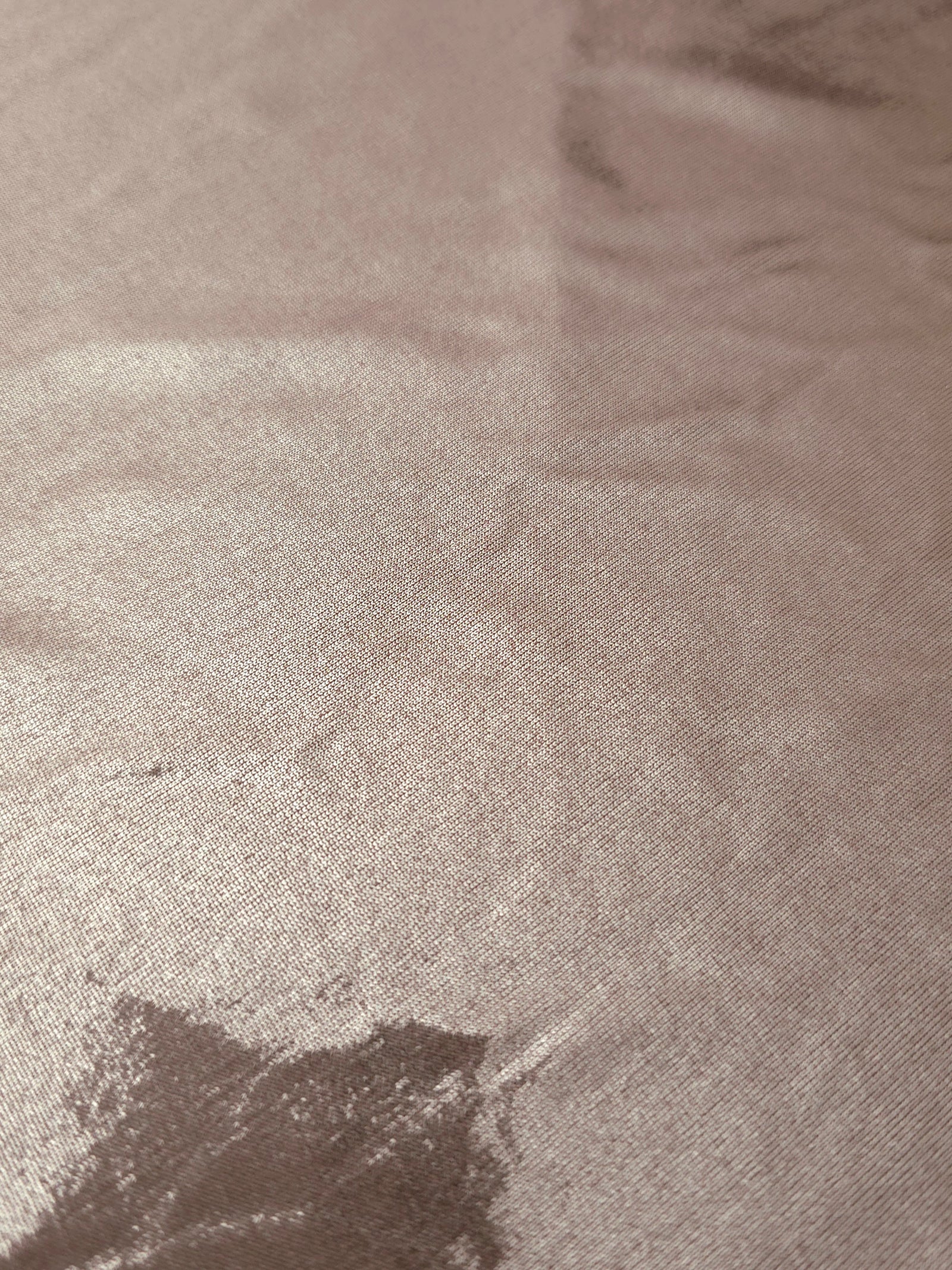 Texture view of Dusty Rose Taupe metallic stretch fabric, highlighting foil shimmer and surface detail for performance apparel