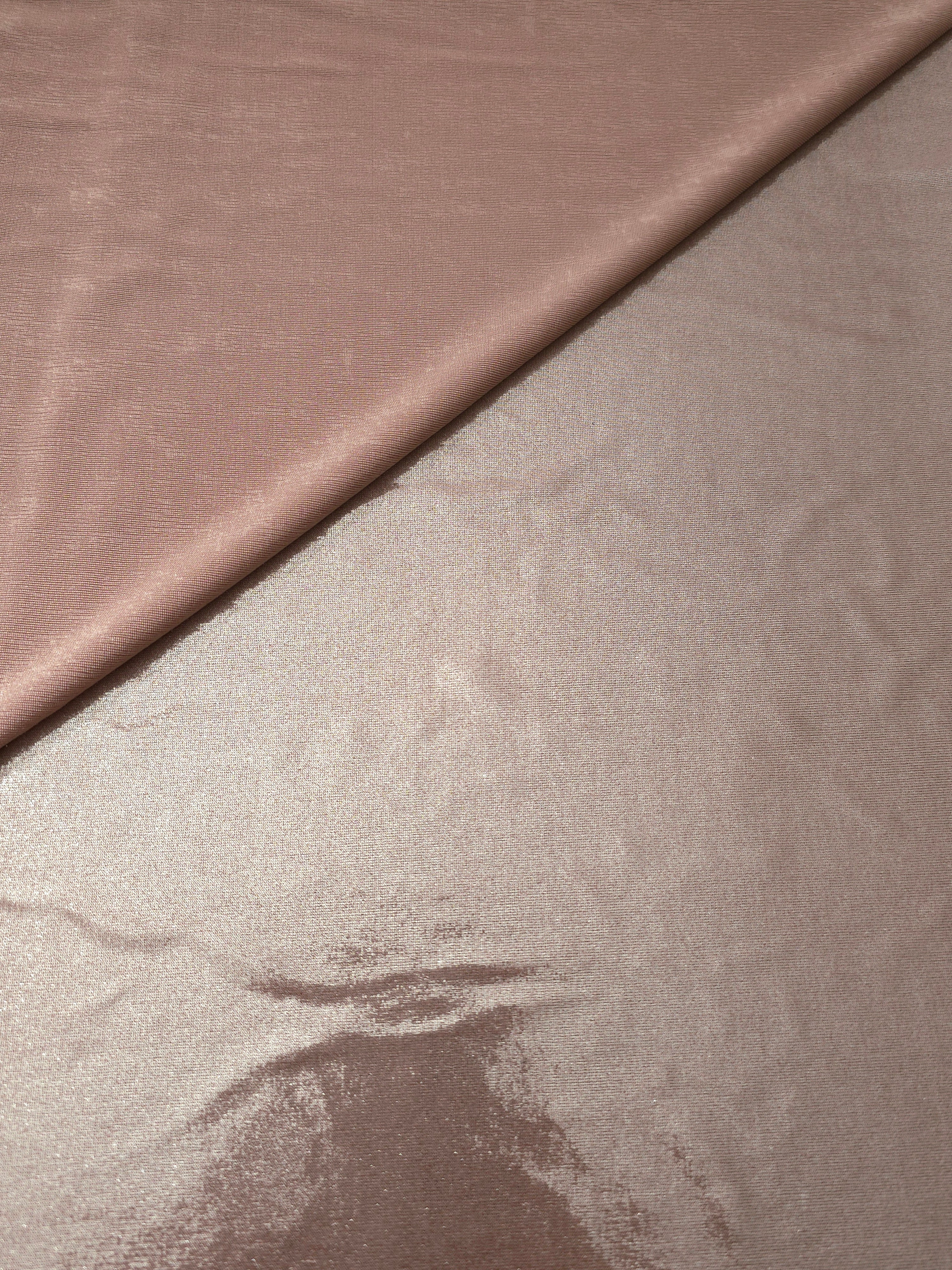 Gently folded Dusty Rose Taupe shimmer spandex fabric showing luminous foil finish for tops, skirts and occasion garments