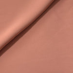 Dusty Rose Taupe opaque Korean polyester crepe in a soft fold, showing flowing drape for garment making