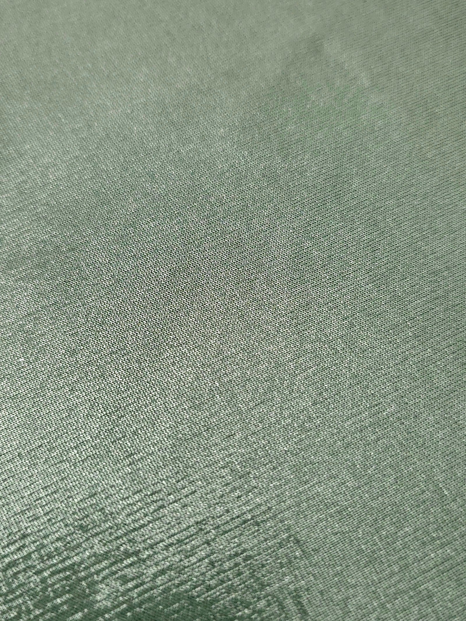Close-up of Dusty Sage Green metallic foiled spandex showing reflective surface texture and the detailed shimmer finish