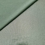 Dusty Sage Green shimmer spandex in a soft fold, showing metallic foil sheen and flexible drape for tops, skirts and costumes