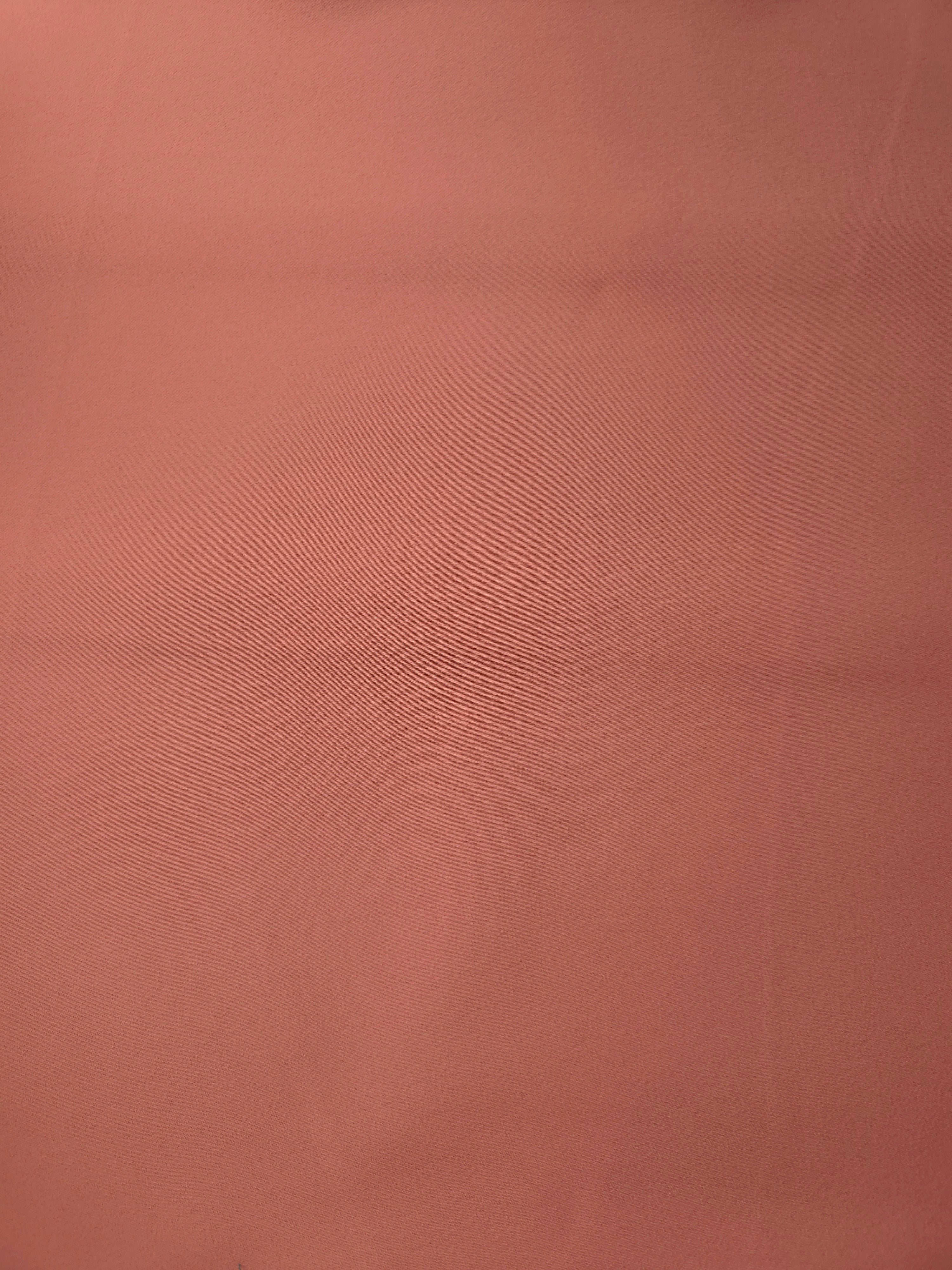Dusty Terracotta Italian polyester crepe shown flat, smooth woven dressmaking fabric with a silky-soft finish