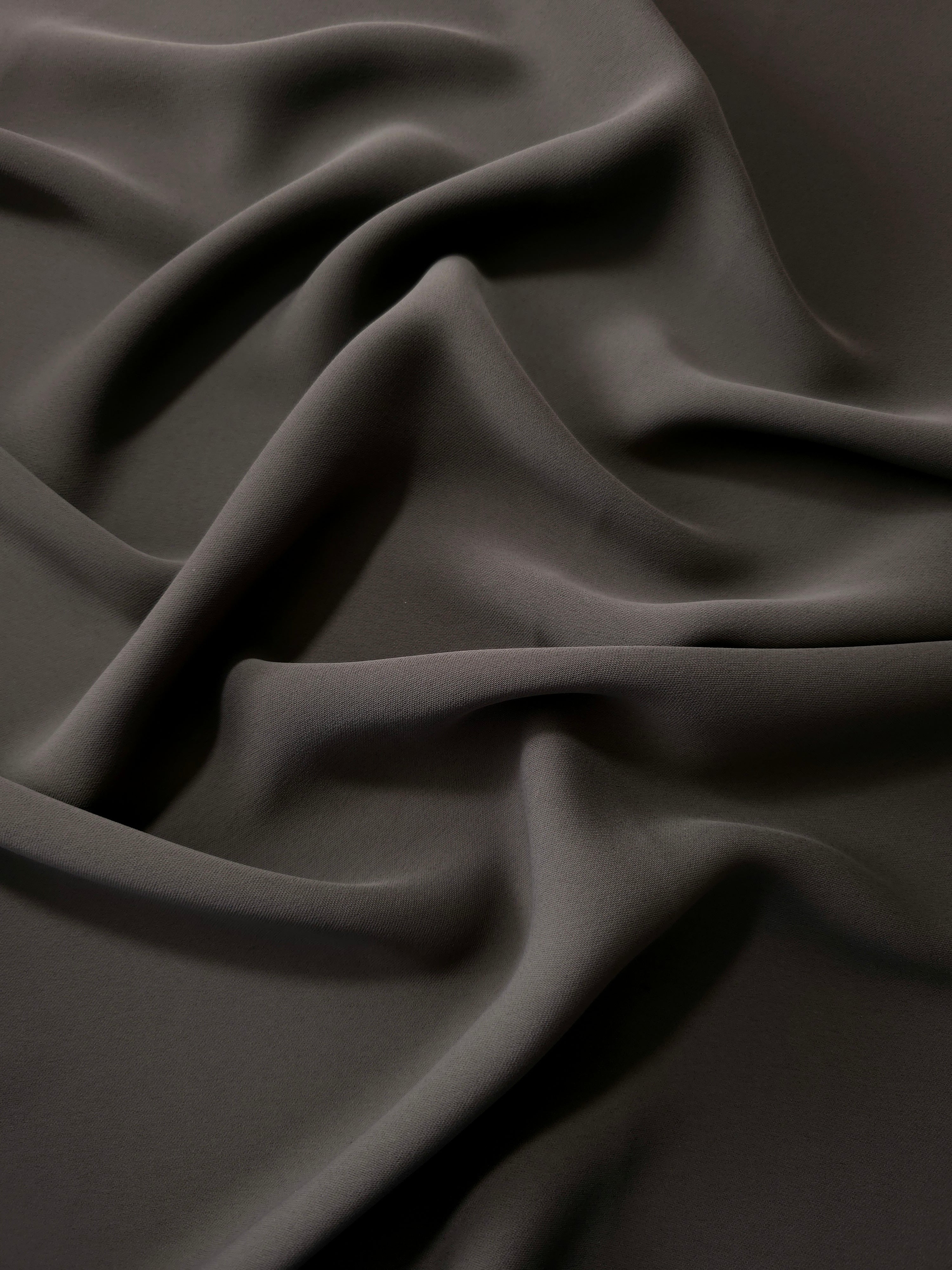 Espresso Taupe polyester crepe in long draped folds, showing flowing coverage for abayas and modest fashion