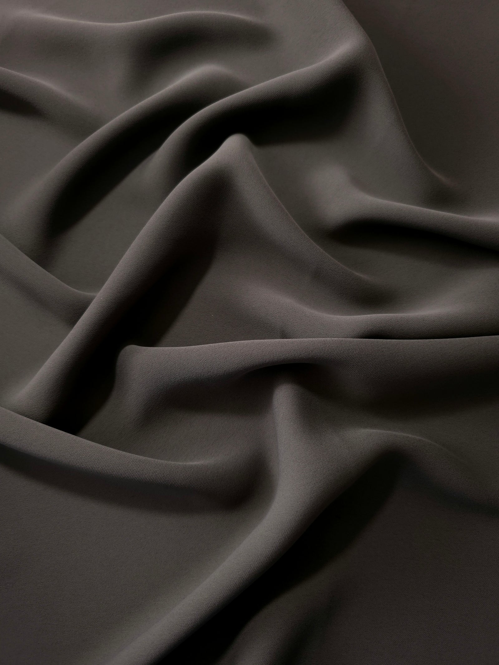 Espresso Taupe polyester crepe in long draped folds, showing flowing coverage for abayas and modest fashion
