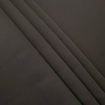 Espresso Taupe Korean crepe in layered folds, showing soft structure and slight mechanical stretch for skirts