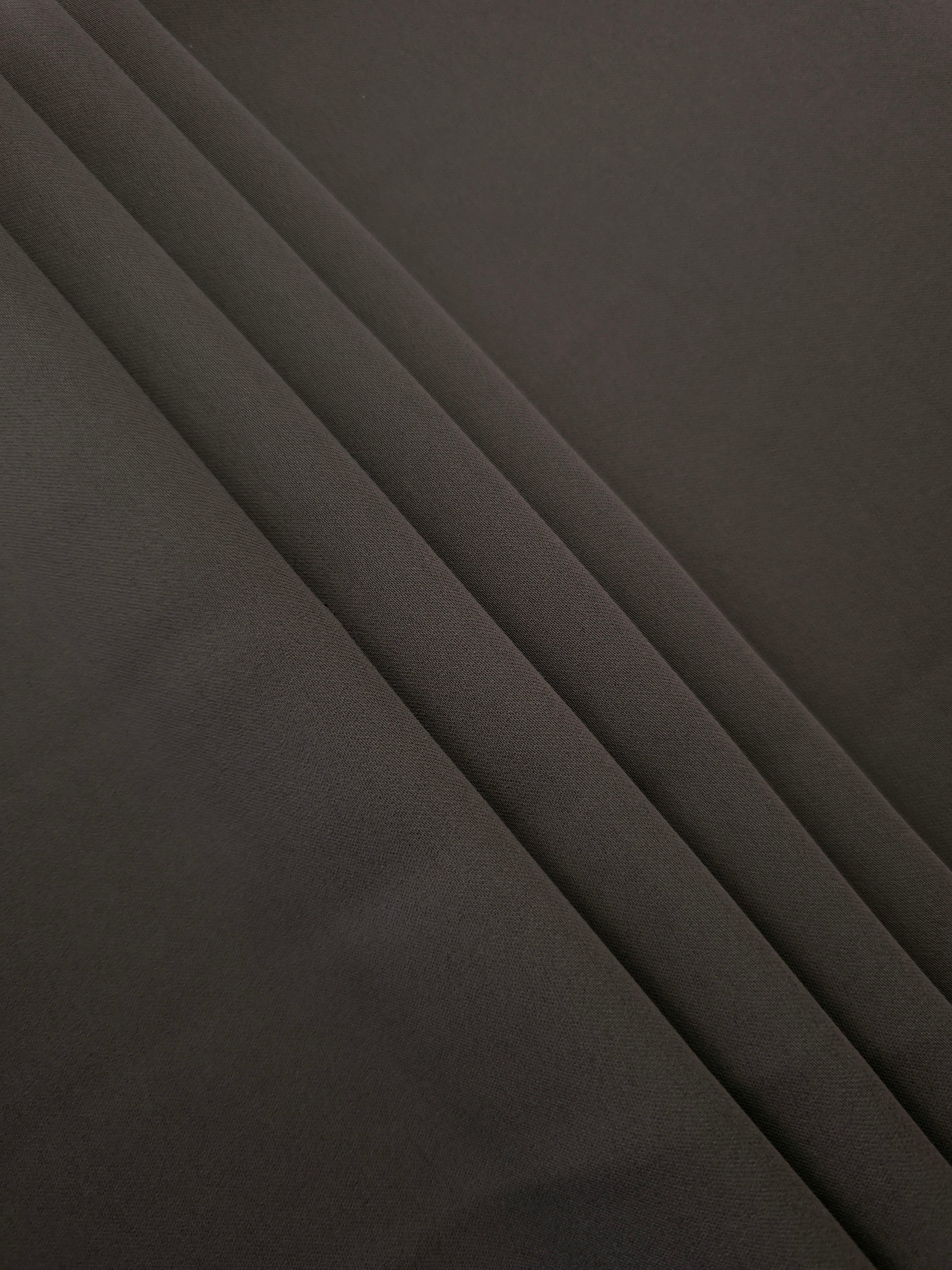 Espresso Taupe Korean crepe in layered folds, showing soft structure and slight mechanical stretch for skirts