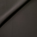 Soft fold of Espresso Taupe opaque polyester crepe showing fluid dressmaking drape for dresses and skirts