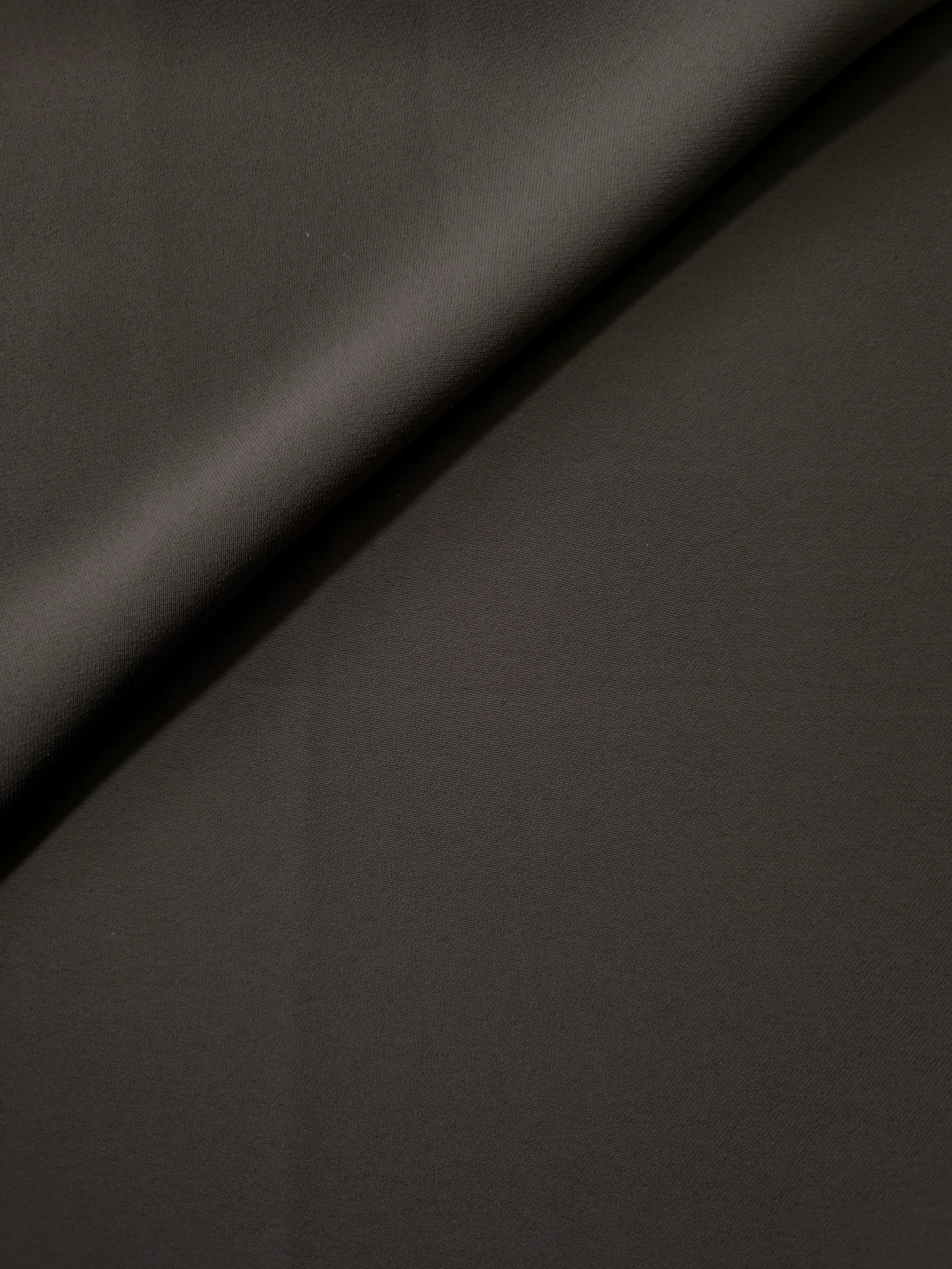 Soft fold of Espresso Taupe opaque polyester crepe showing fluid dressmaking drape for dresses and skirts