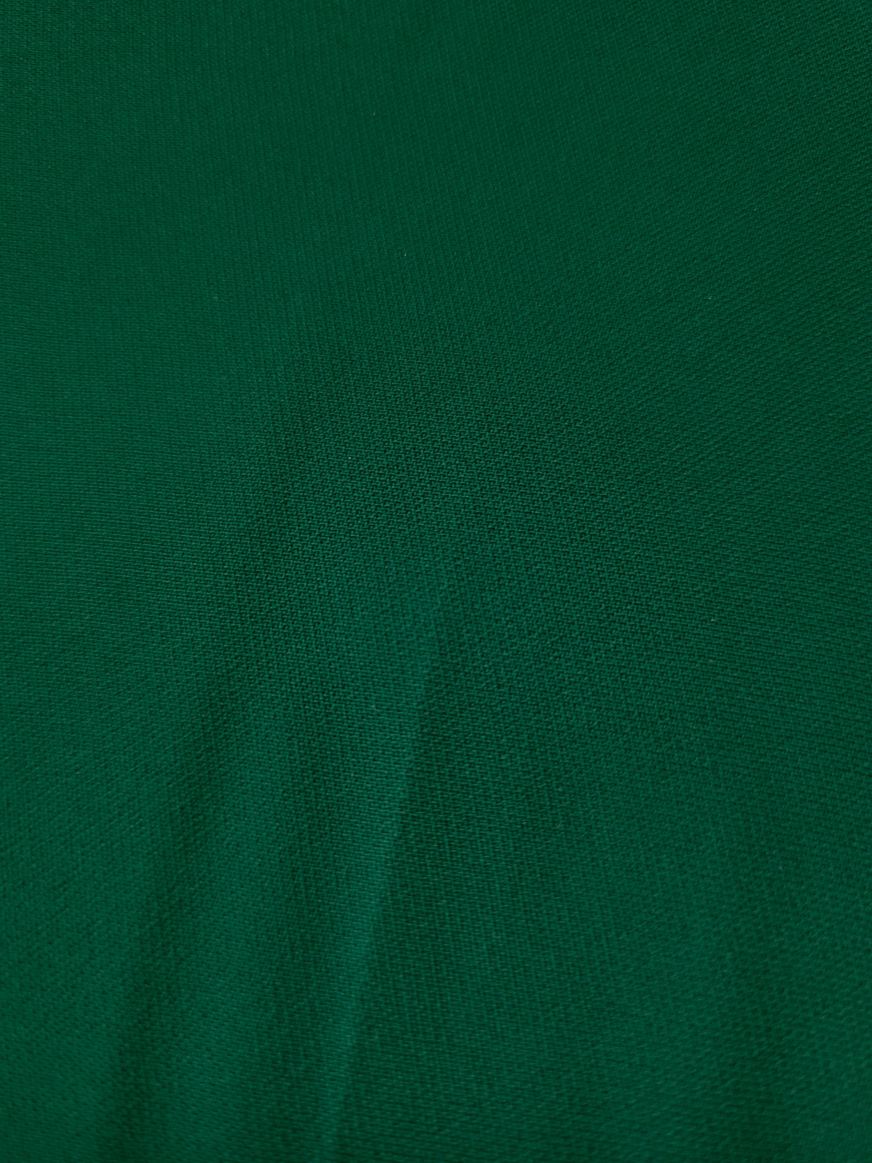 Woven close-up of Forest Green mechanical polyester crepe showing smooth texture and a soft silky-feel finish