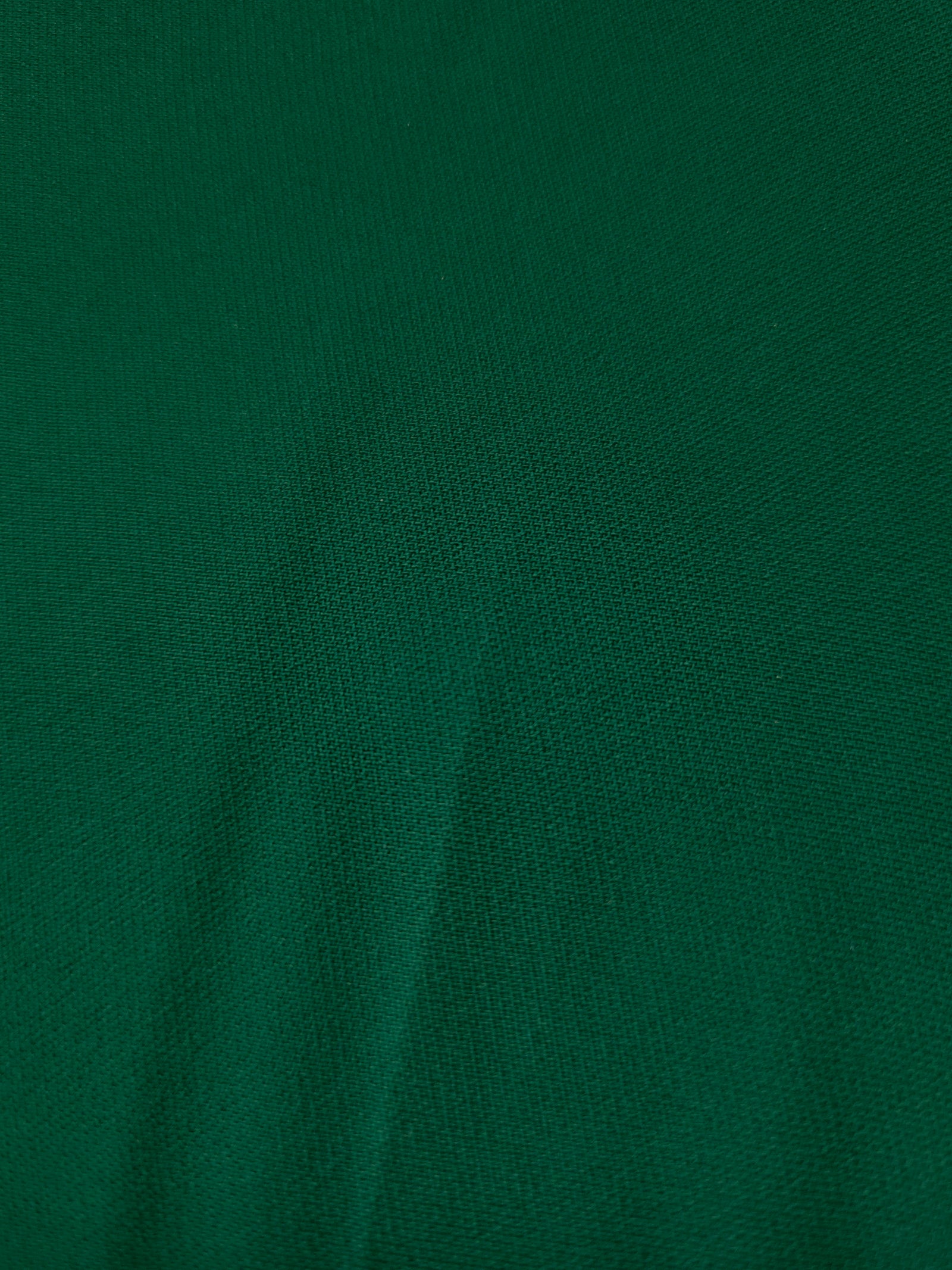 Woven close-up of Forest Green mechanical polyester crepe showing smooth texture and a soft silky-feel finish