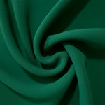 Spiral styling of Forest Green Korean polyester crepe showing supple drape for abayas, dresses and occasionwear