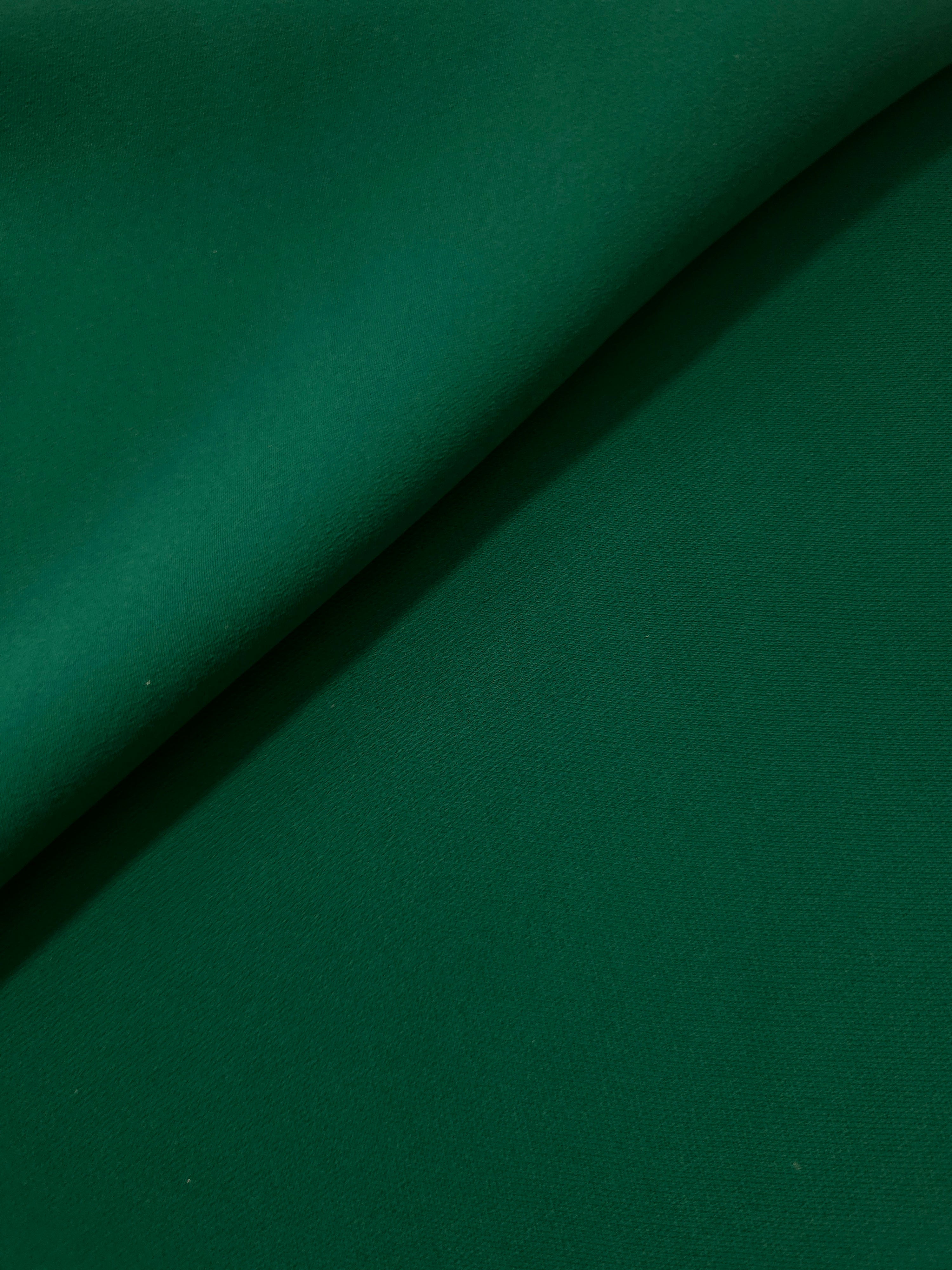 Forest Green polyester crepe gathered into a soft fold, showing fluid drape for dresses and blouse making
