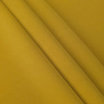 Layered Golden Ochre Korean polyester crepe showing gentle mechanical stretch and soft structure for dressmaking