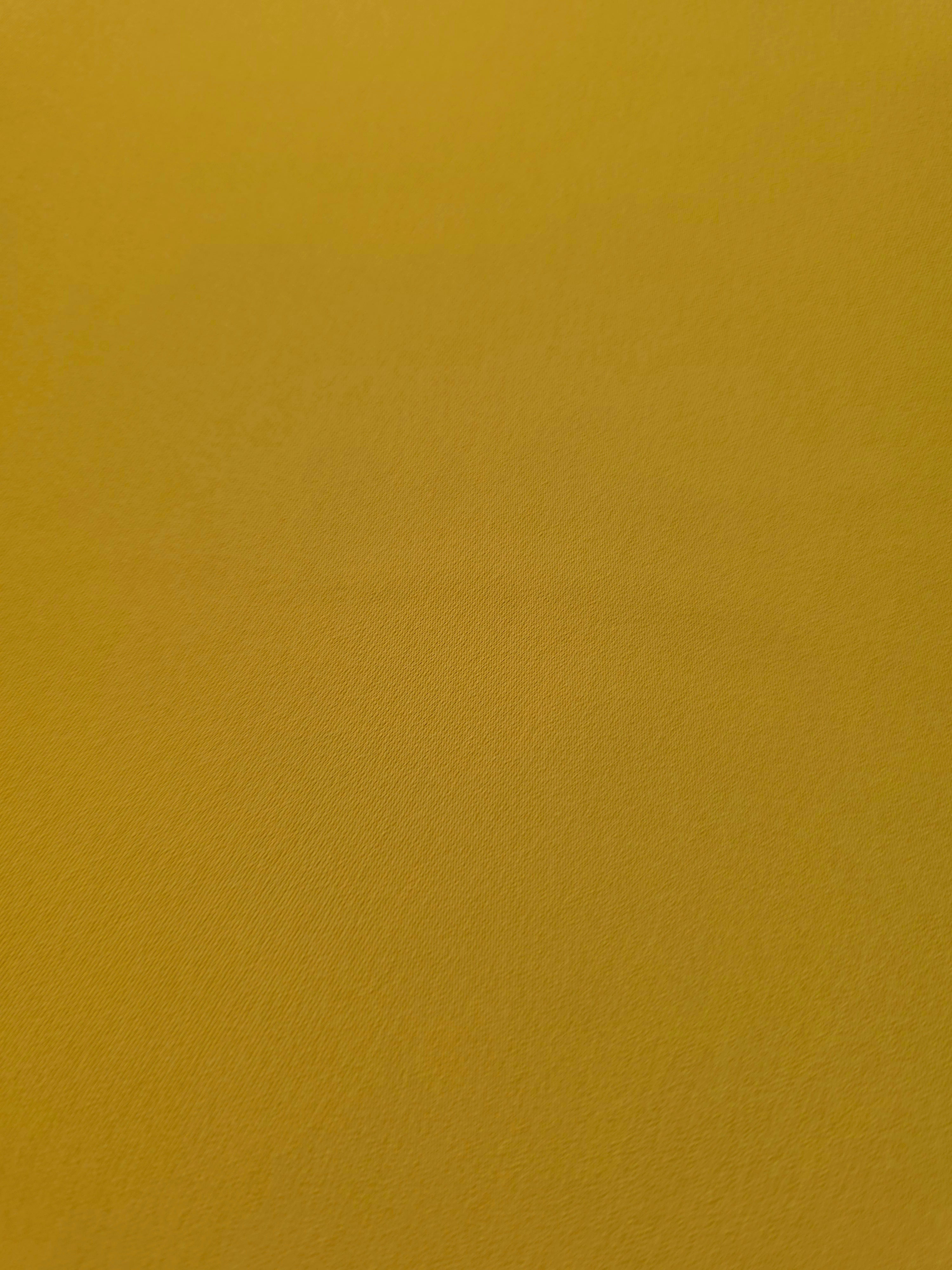 Golden Ochre mechanical polyester crepe in close-up, showing fine woven texture and a silky-soft surface