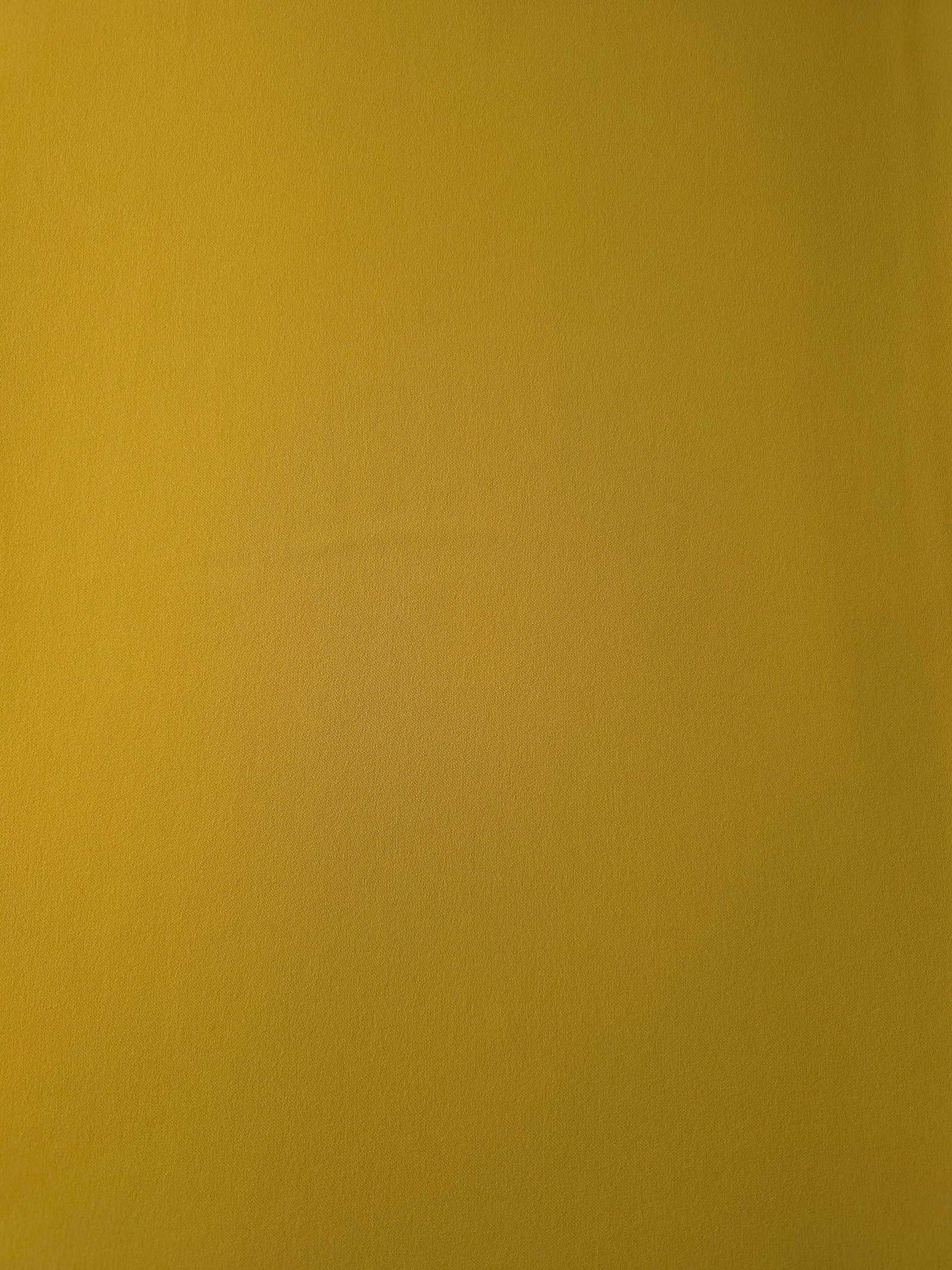 Golden Ochre opaque Korean polyester crepe shown flat, 205 GSM smooth woven fabric for dressmaking