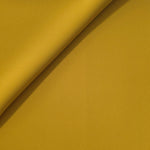 Golden Ochre opaque Korean polyester crepe in a soft fold, showing flowing drape for garment making
