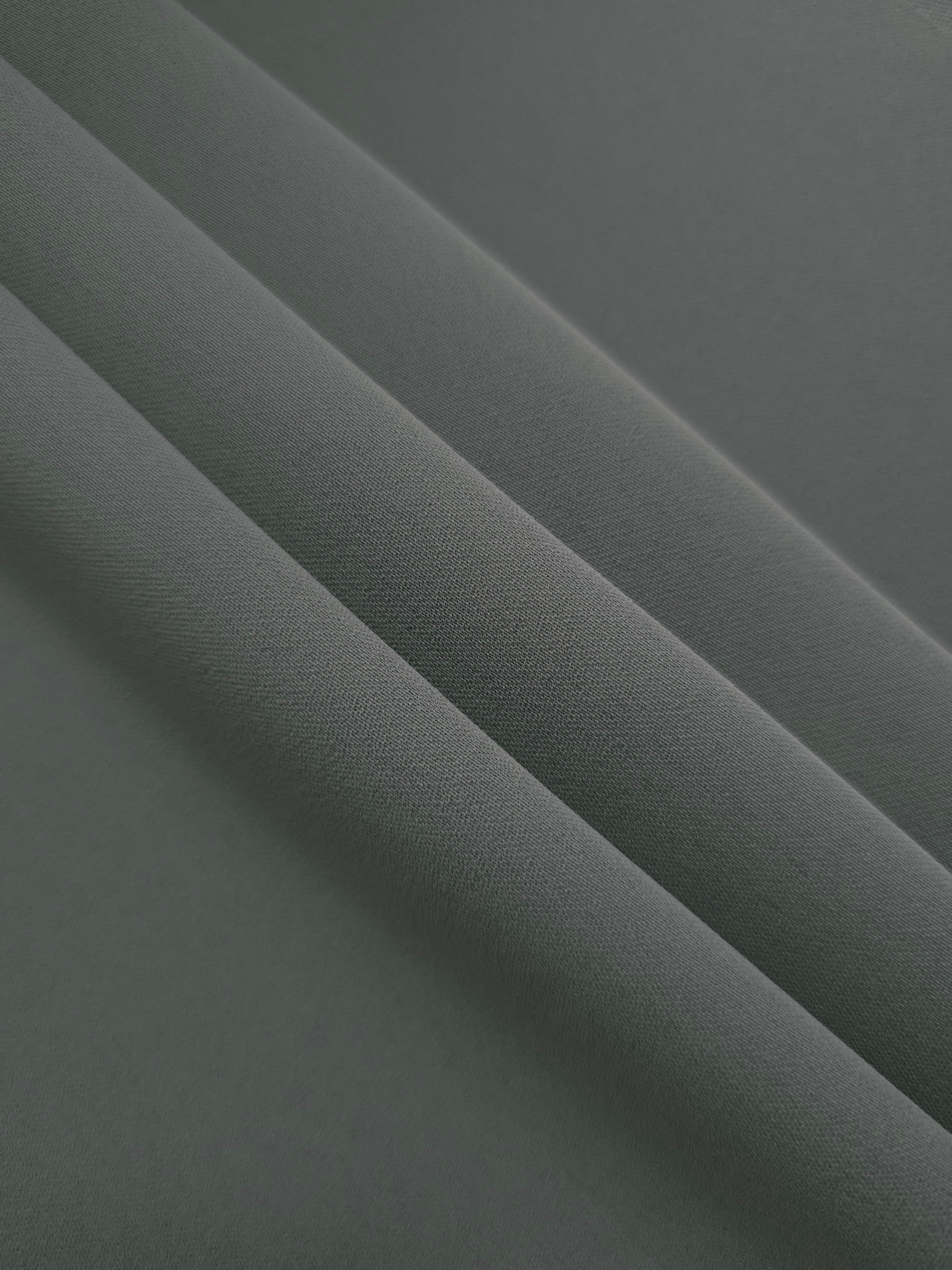 Layered Graphite Gray mechanical polyester crepe showing soft structure and gentle stretch for light tailoring