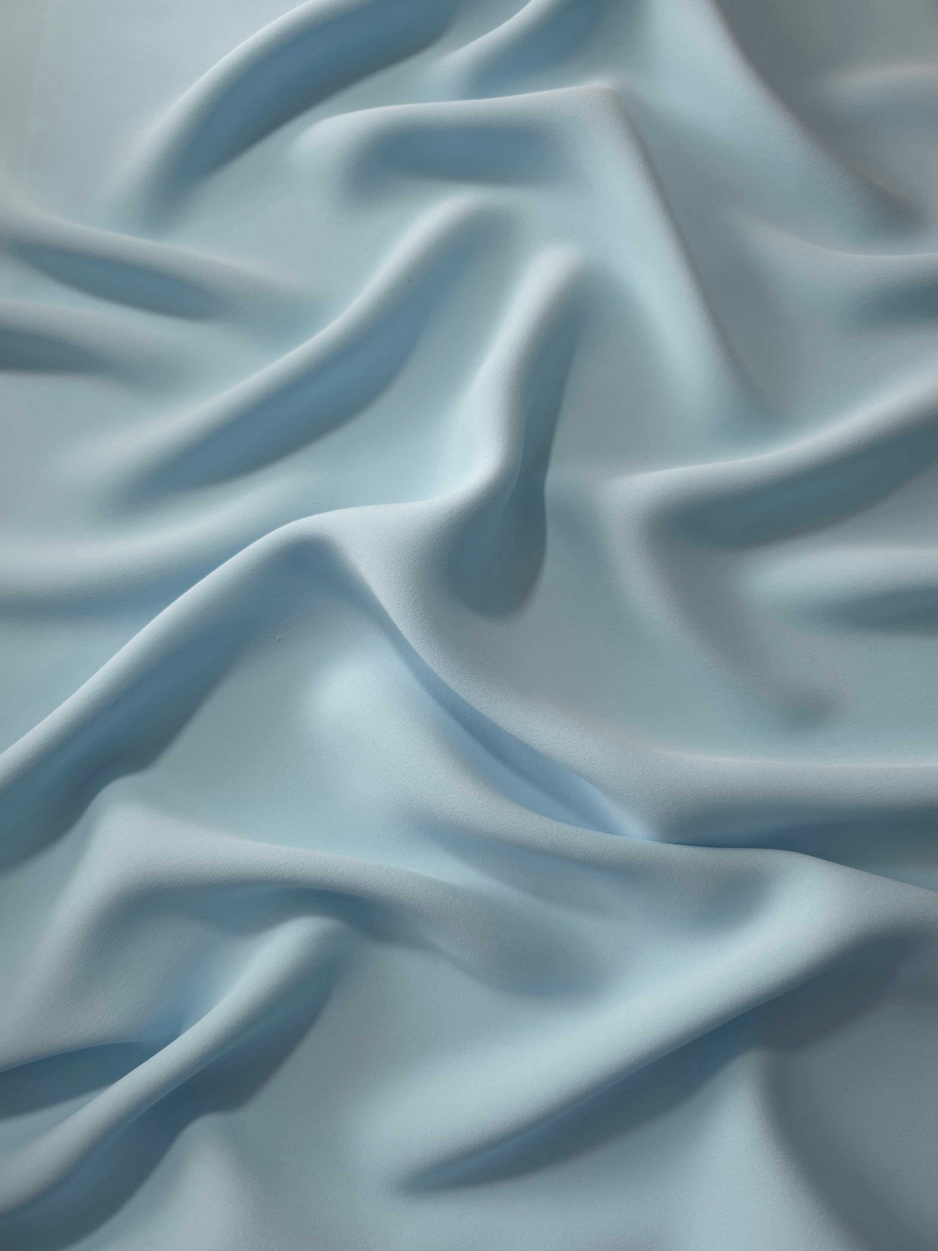 Fluid folds of Ice Blue opaque Korean crepe, a dress fabric suited to eveningwear and flowing skirts