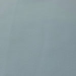Texture detail of Ice Blue mechanical polyester crepe, a smooth woven fabric with a soft silky hand