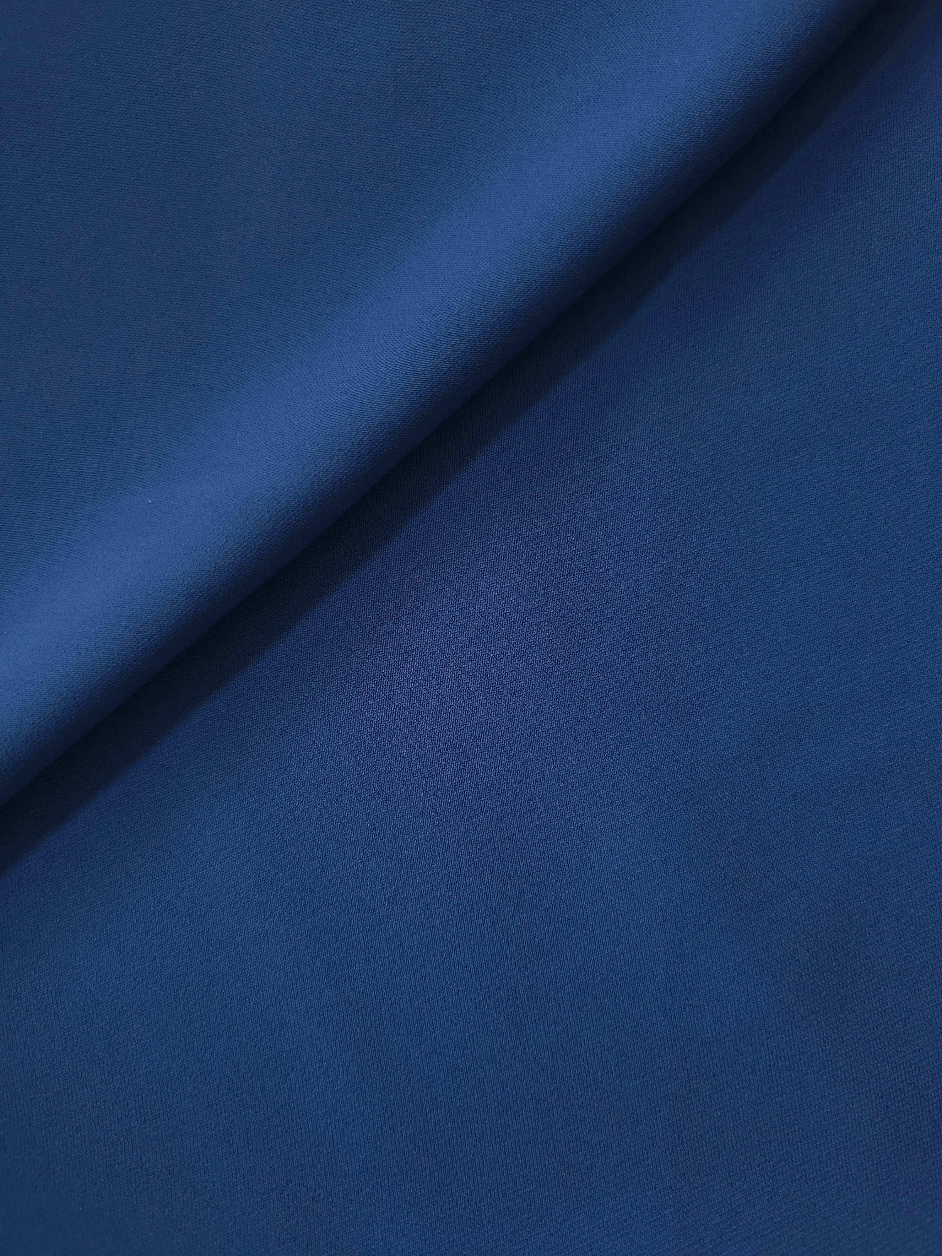Indigo Navy Blue Italian crepe in a soft fold, showing fluid drape for blouses, dresses and flowing skirts