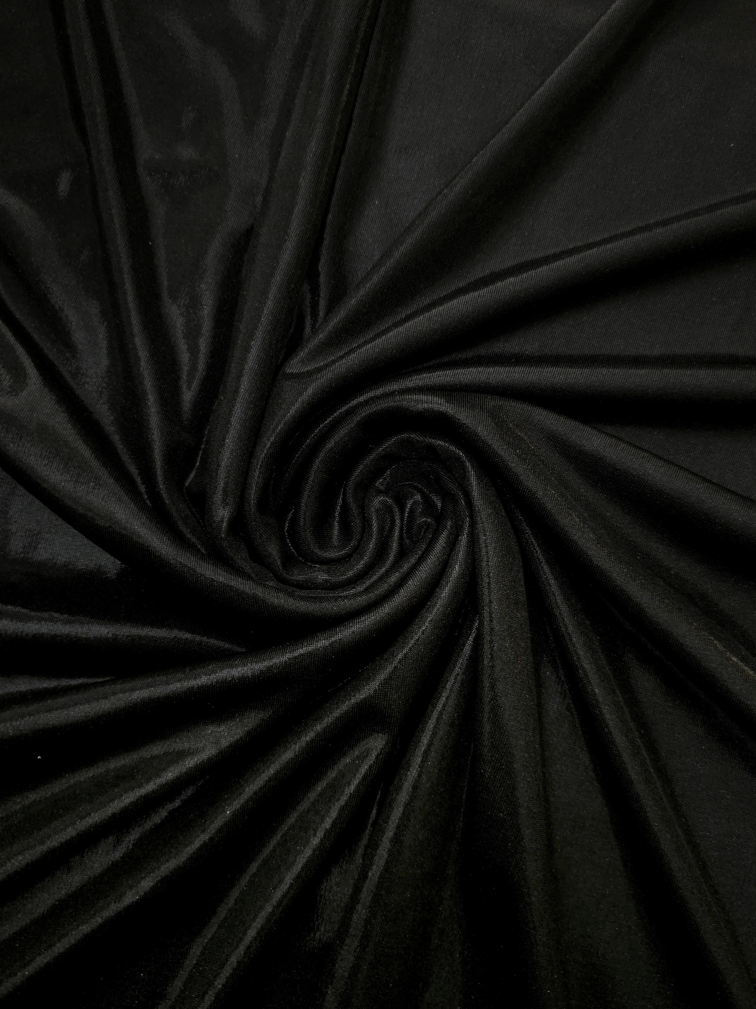 Swirled Jet Black metallic foiled spandex showing fluid movement and luminous sheen for dresses, dancewear and stage costumes