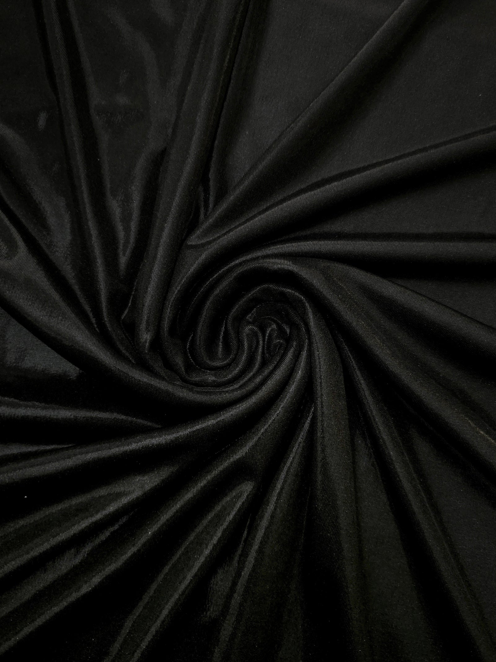 Swirled Jet Black metallic foiled spandex showing fluid movement and luminous sheen for dresses, dancewear and stage costumes