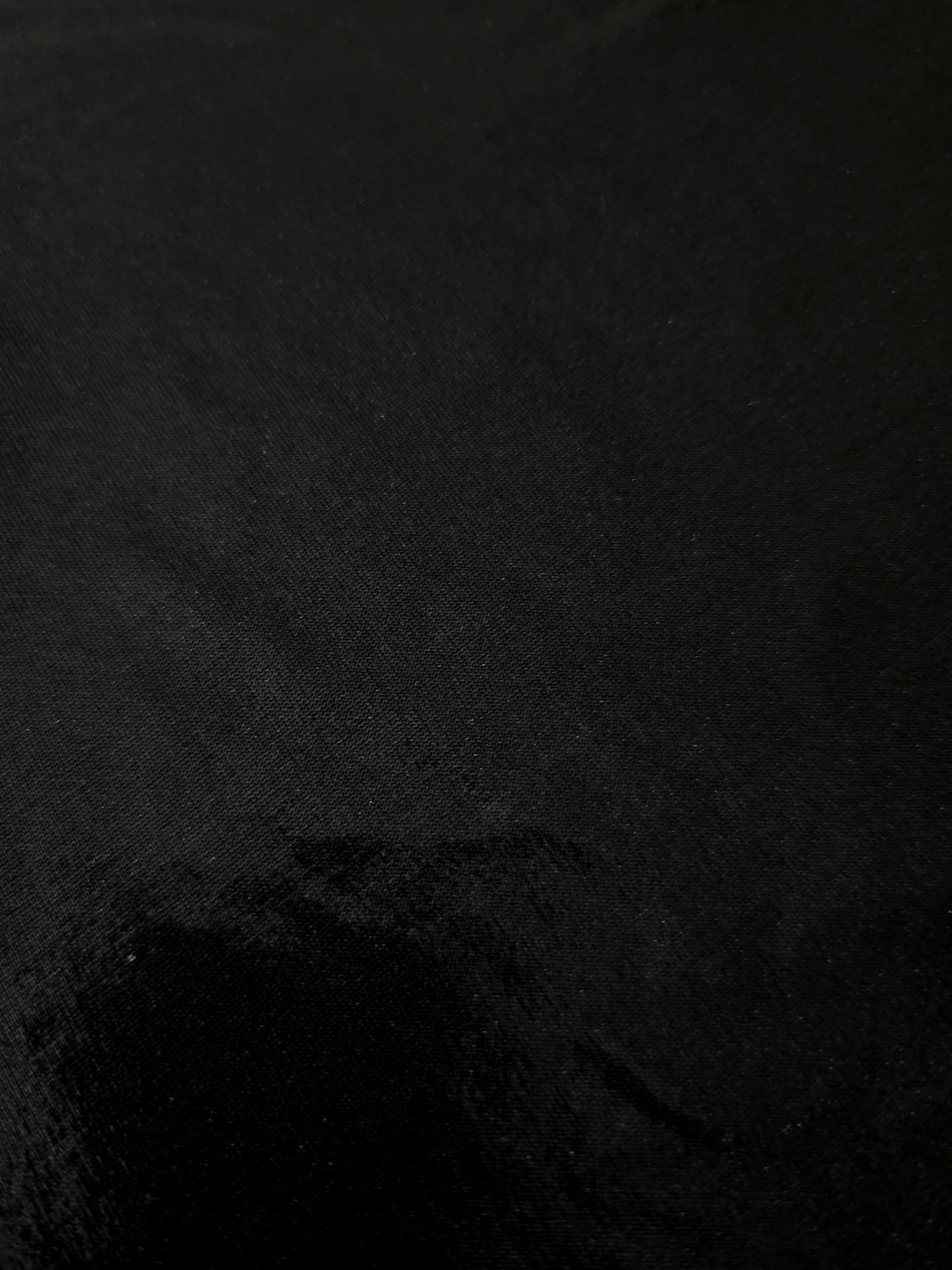 Jet Black shimmer stretch fabric close-up, revealing metallic foil texture and reflective detail for fashion and costume sewing