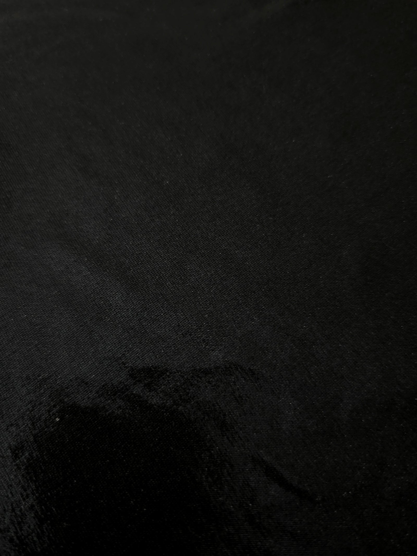 Jet Black shimmer stretch fabric close-up, revealing metallic foil texture and reflective detail for fashion and costume sewing