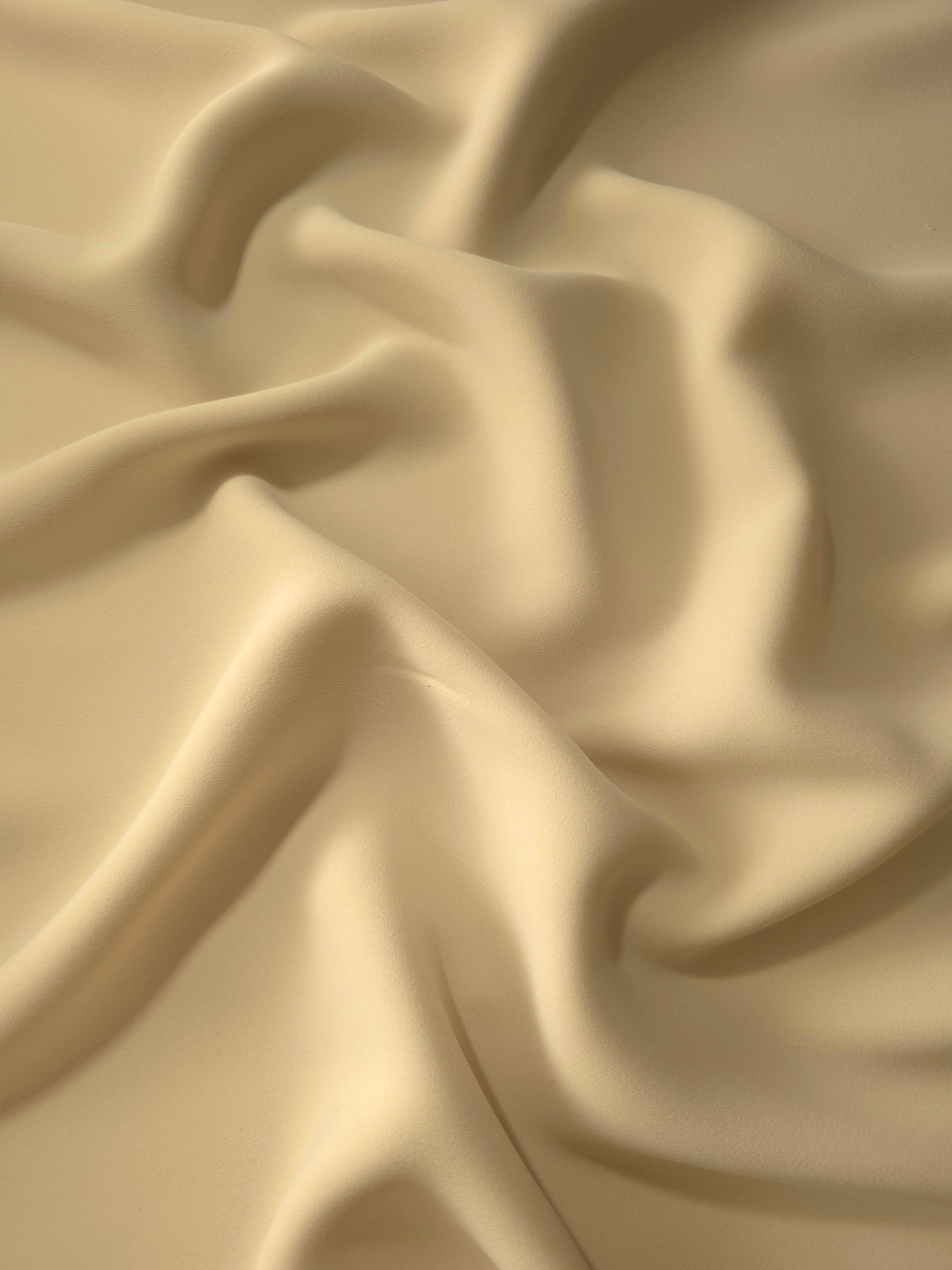 Khaki Beige Italian crepe in long draped folds, showing flowing coverage for abayas and modest garments