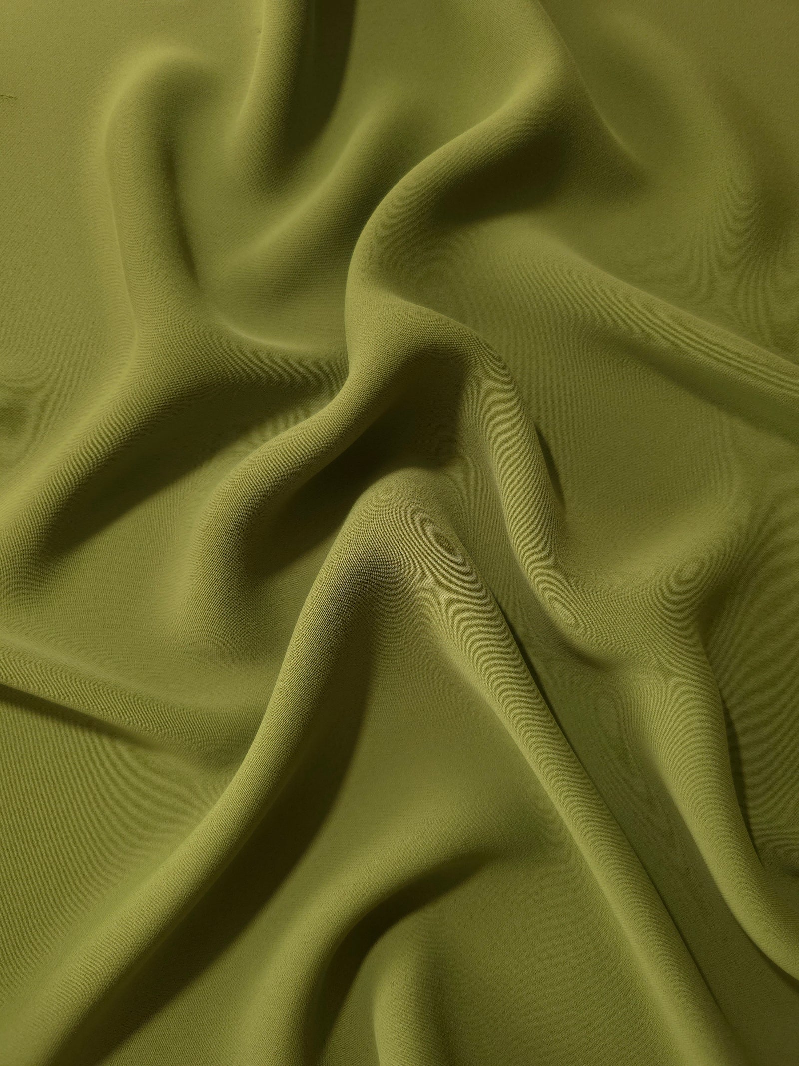 Khaki Olive Green polyester crepe in long draped folds, showing flowing coverage for abayas and modest fashion