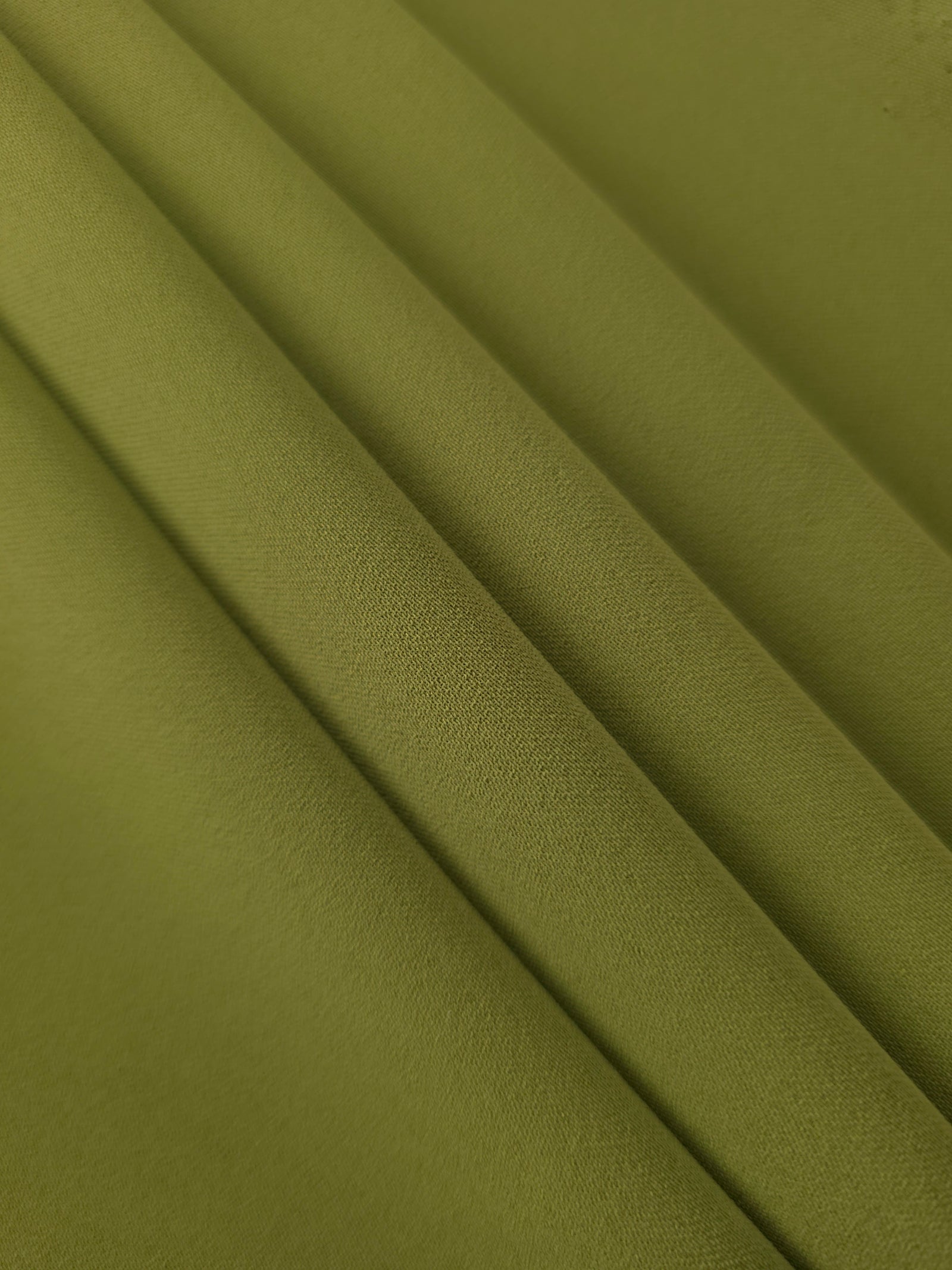 Khaki Olive Green Korean crepe in layered folds, showing soft structure and slight mechanical stretch for skirts