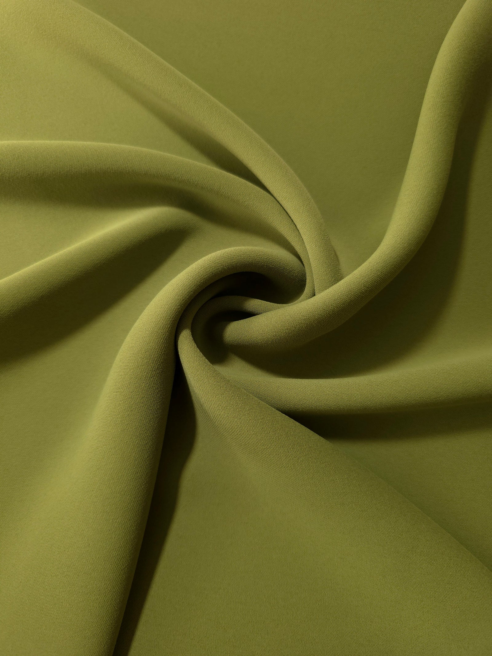 Swirled Khaki Olive Green Korean crepe showing fluid movement and silky drape for dresses and occasionwear