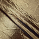 Layered folds of Khaki Taupe foiled stretch fabric showing shimmer, body and movement for performance outfits and statement garments