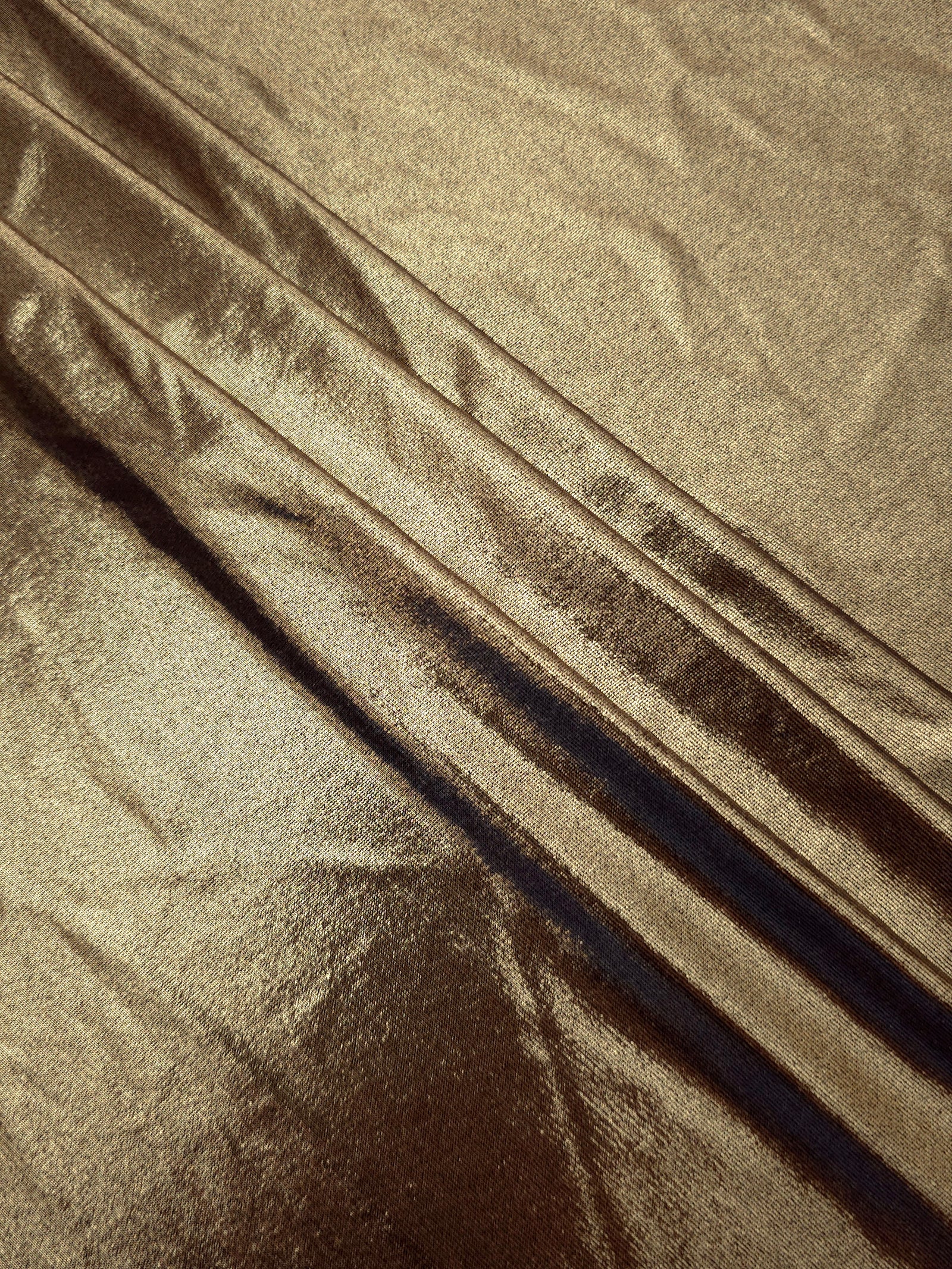 Layered folds of Khaki Taupe foiled stretch fabric showing shimmer, body and movement for performance outfits and statement garments