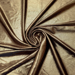 Khaki Taupe metallic stretch fabric in a flowing swirl, emphasizing foil shimmer and drape for partywear and statement fashion