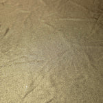 Detailed close-up of Khaki Taupe foiled spandex fabric showing its luminous metallic surface and fine reflective texture
